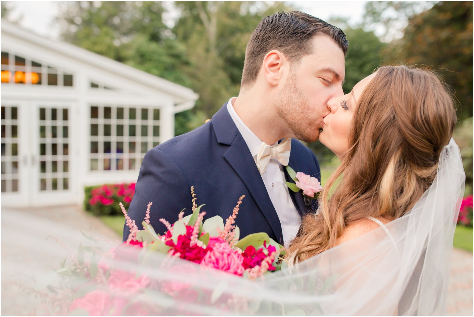 romantic photo of bride and groom under veil