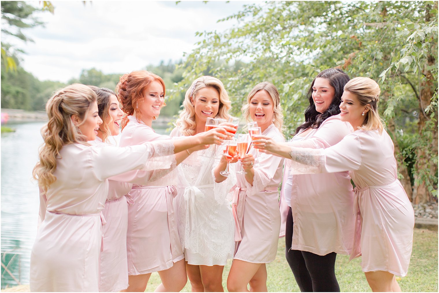 bride and bridesmaids cheer wedding dat at Windows on the Water at Frogbridge