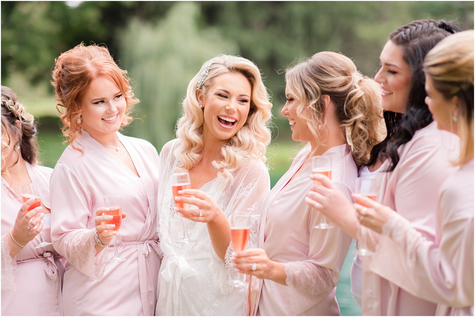 bride laughing with bridesmaids before Windows on the Water at Frogbridge wedding day
