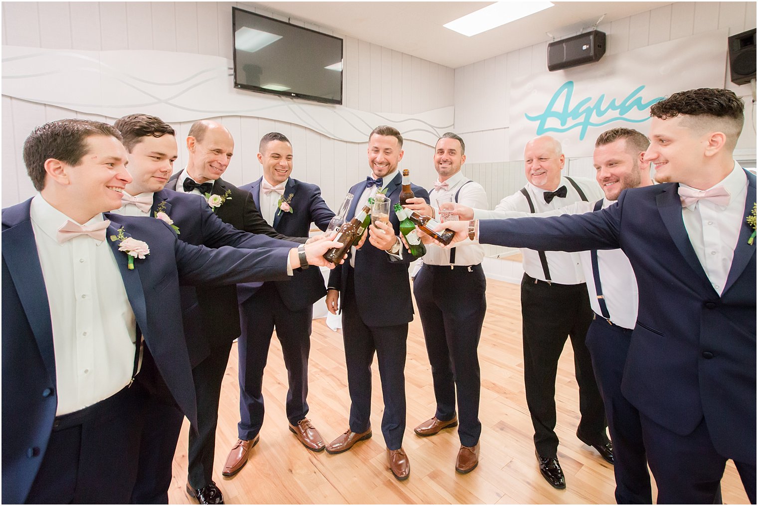 groomsmen and groom cheer wedding day photographed by Idalia Photography