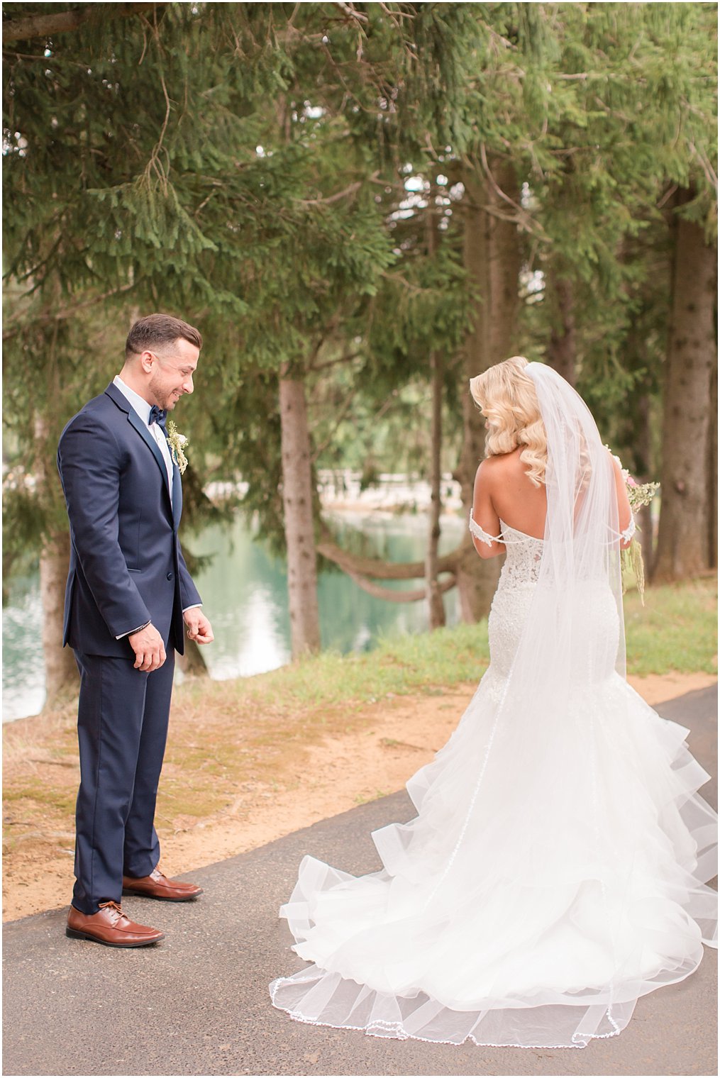 groom admires Morilee wedding dress on bride captured by Idalia Photography