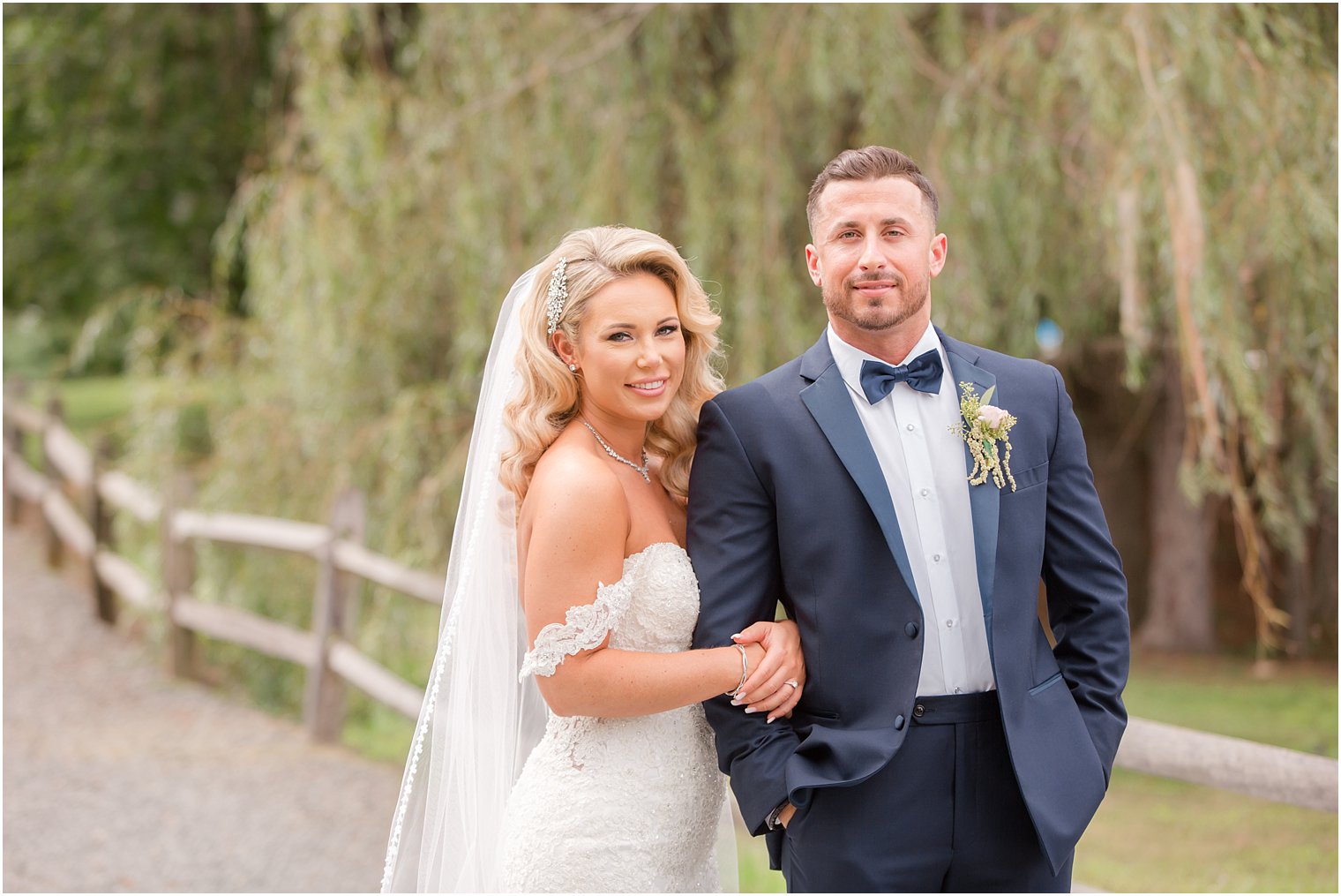 bride in Morilee gown with husband in navy suit at Windows on the Water at Frogbridge