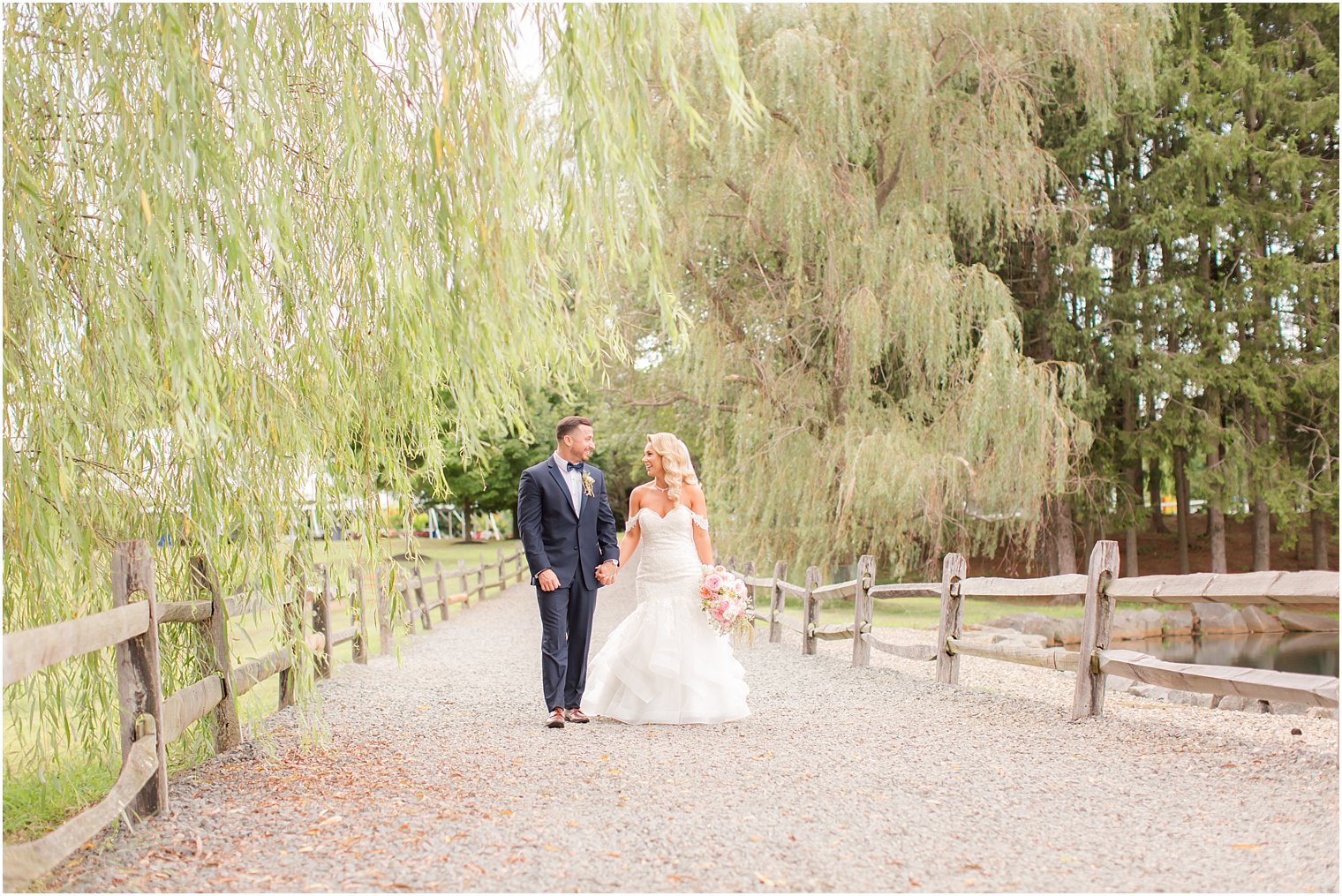 bride and groom with weeping willow at Windows on the Water at Frogbridge