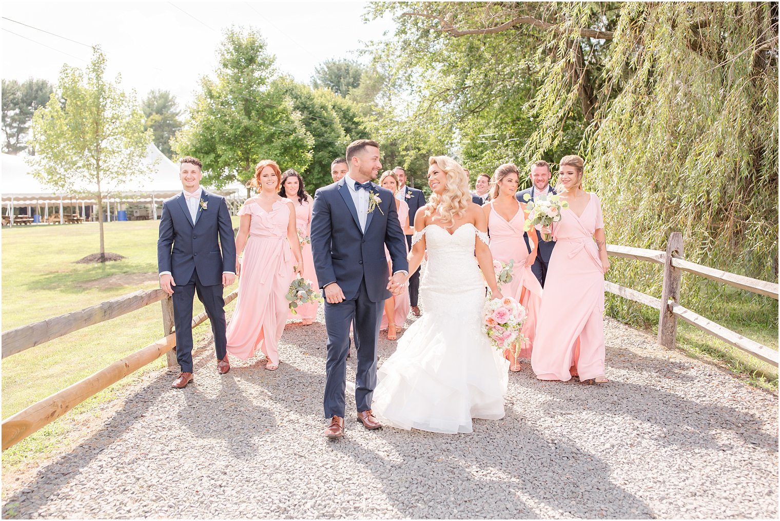 bride and groom with bridal party with pink and navy outfits at Windows on the Water at Frogbridge