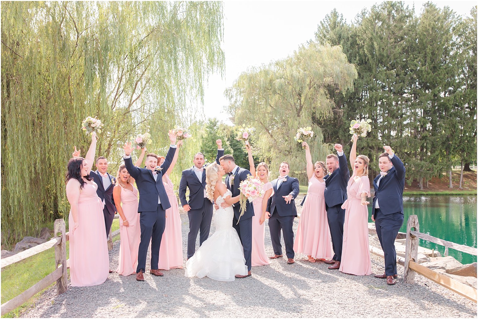 wedding party celebrates wedding at Windows on the Water at Frogbridge