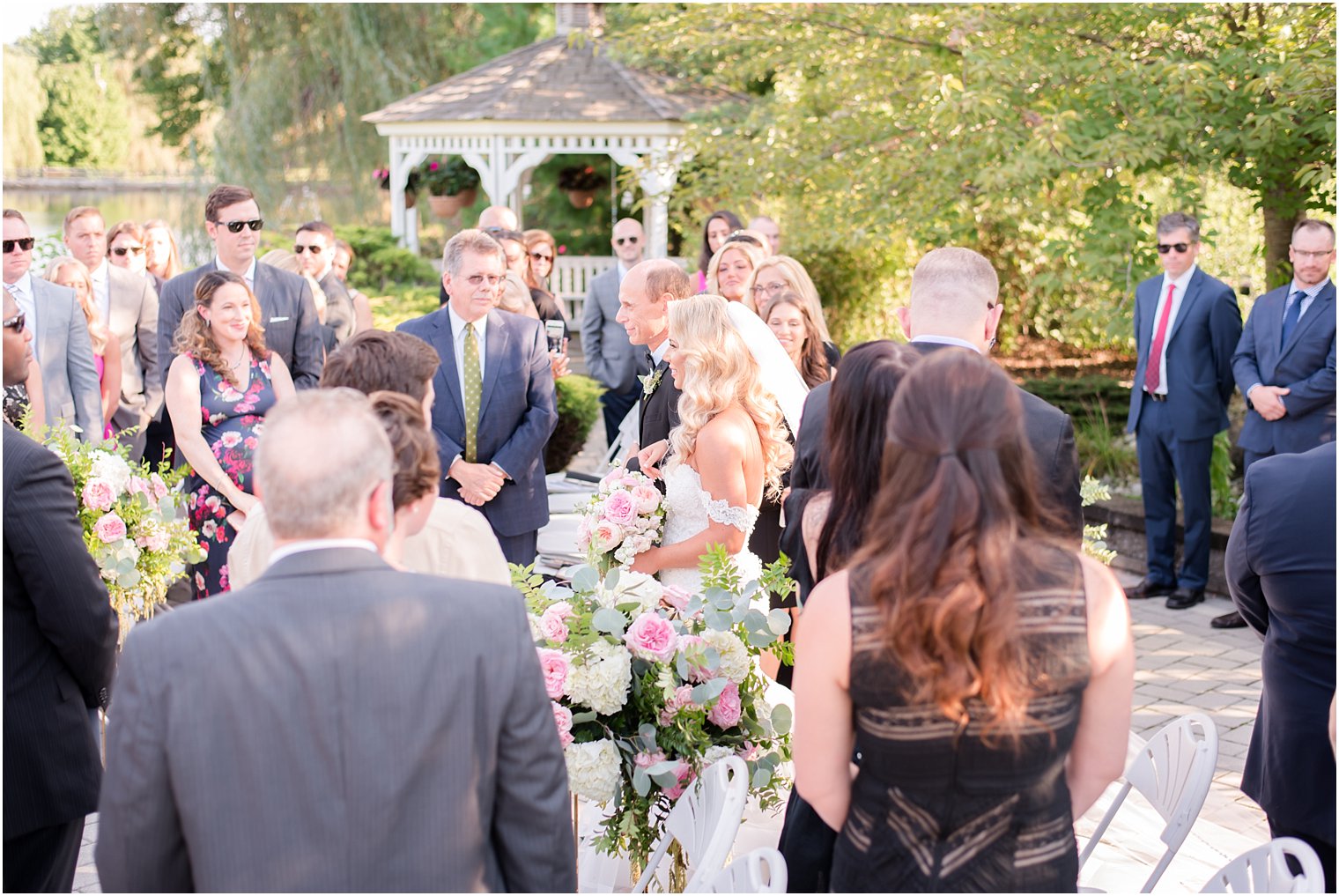 bride walks down the aisle at Windows on the Water at Frogbridge outdoor wedding ceremony