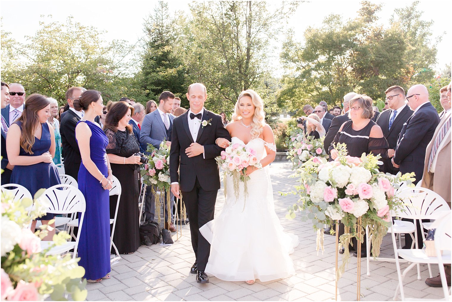 father walks daughter down aisle in Morilee wedding dress at Windows on the Water at Frogbridge