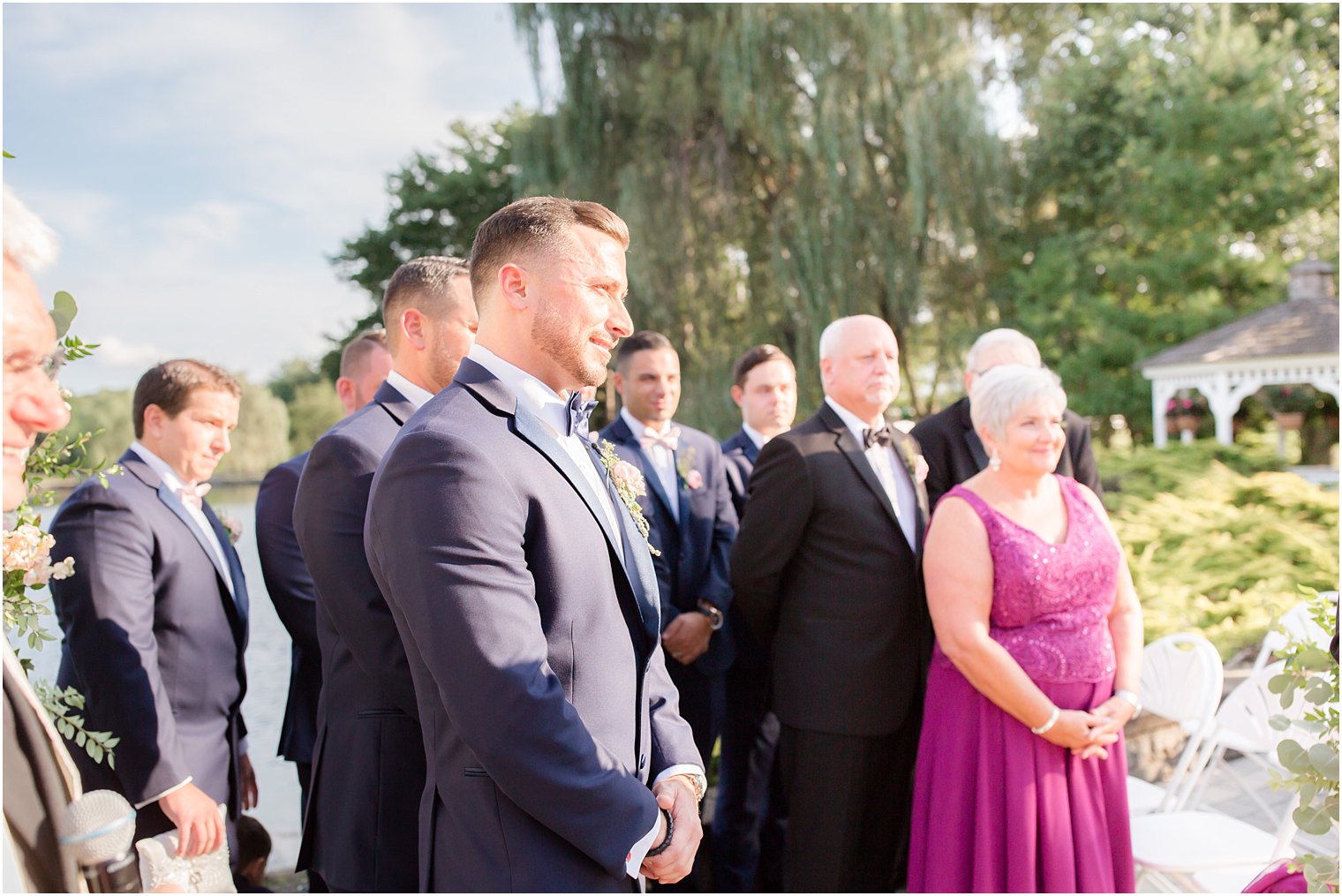 emotional groom watches bride come down the aisle at Windows on the Water at Frogbridge