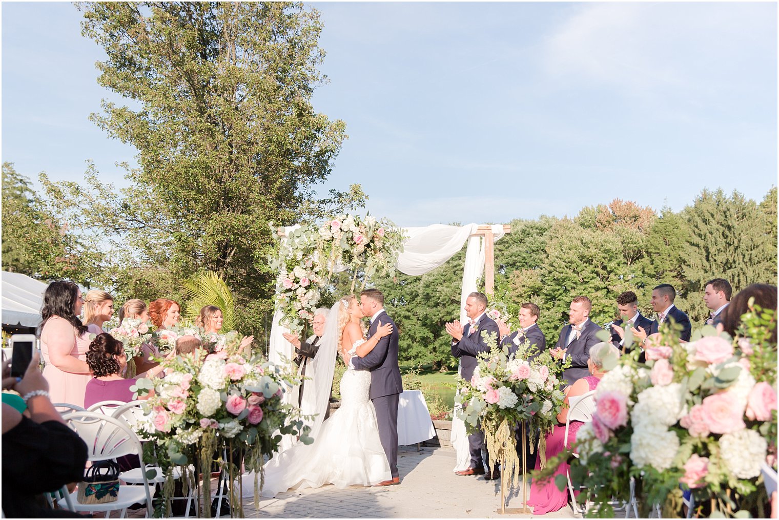 bride and groom kiss during Windows on the Water at Frogbridge ceremony