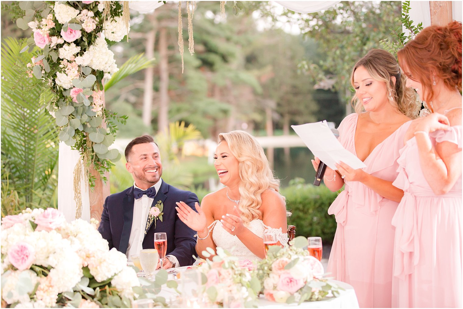 bride and groom laugh during wedding toasts at Windows on the Water at Frogbridge