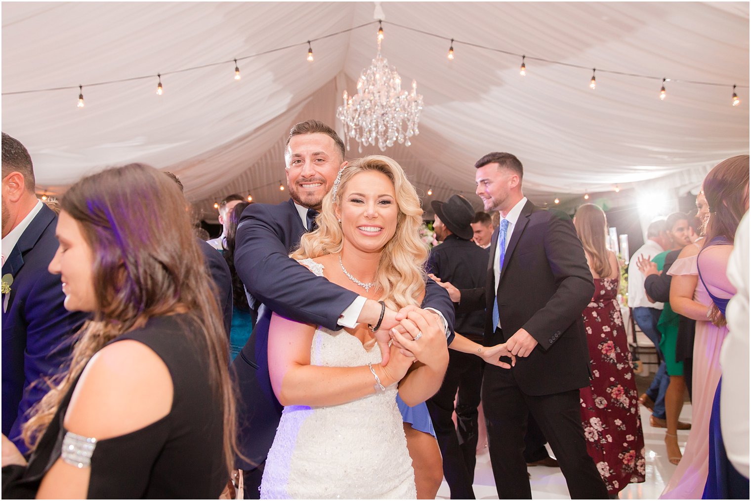 bride and groom pose during wedding reception at Windows on the Water at Frogbridge