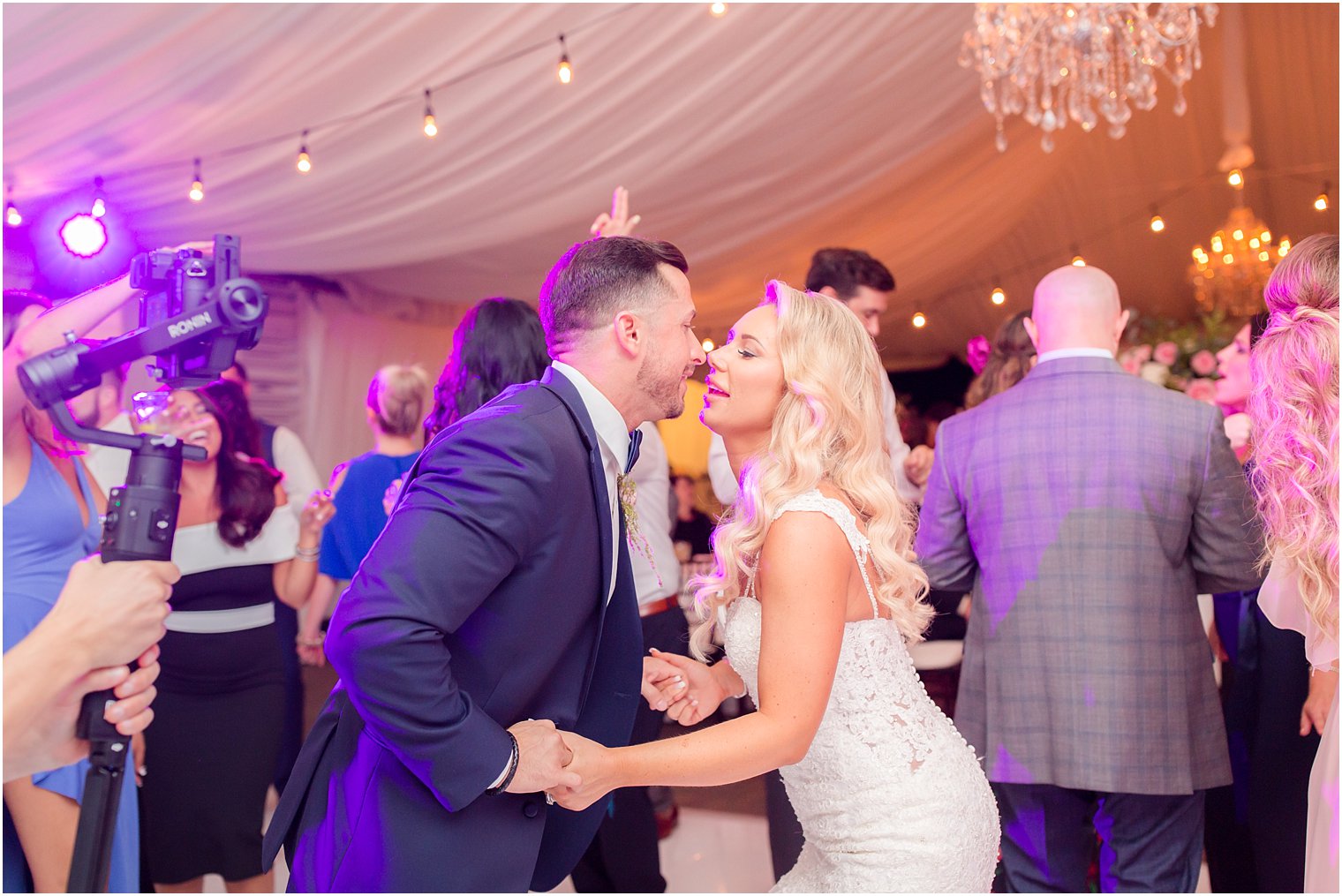 bride and groom dance during tented reception at Windows on the Water at Frogbridge
