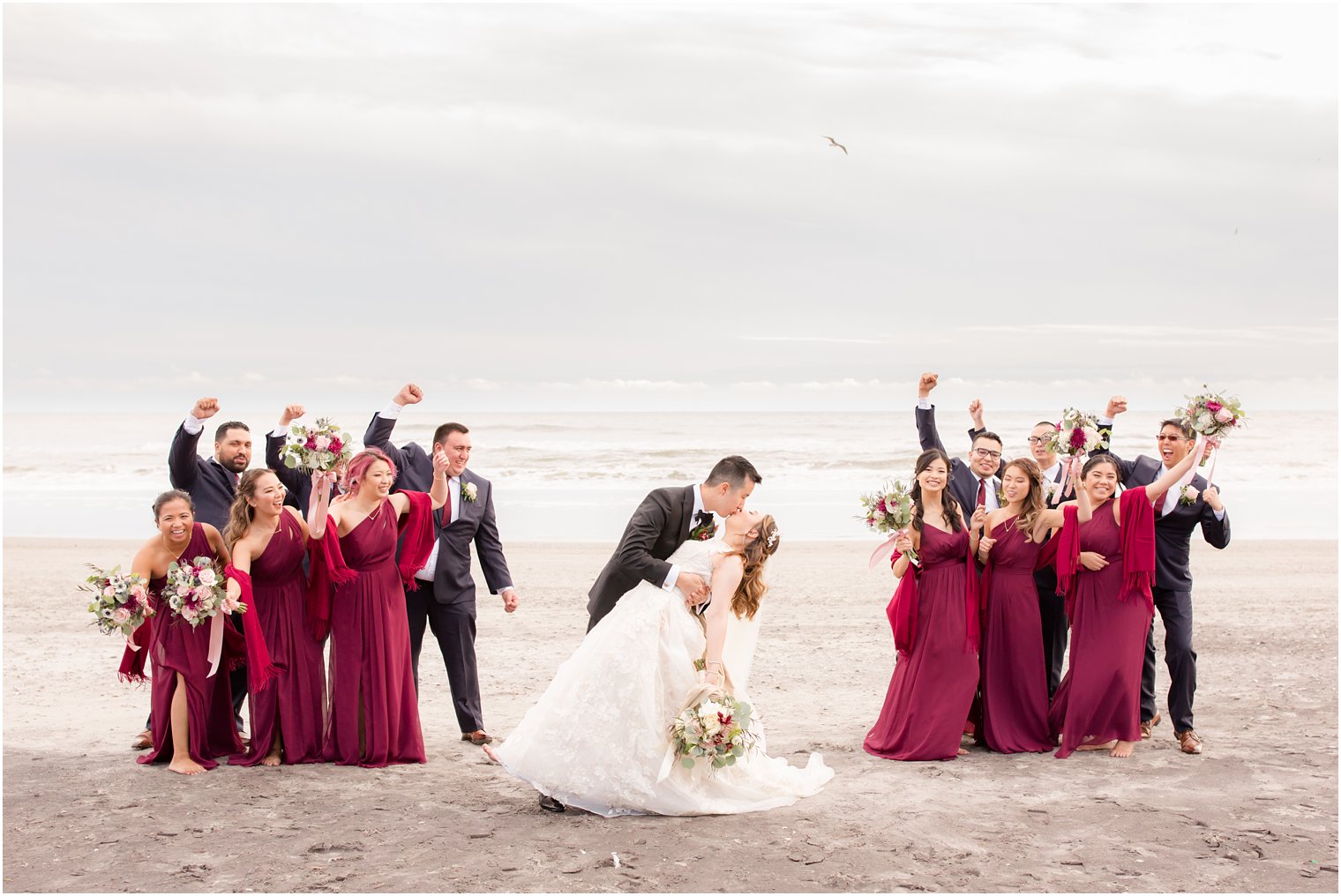 Bridal Party taking fun photos on the beach in Atlantic City