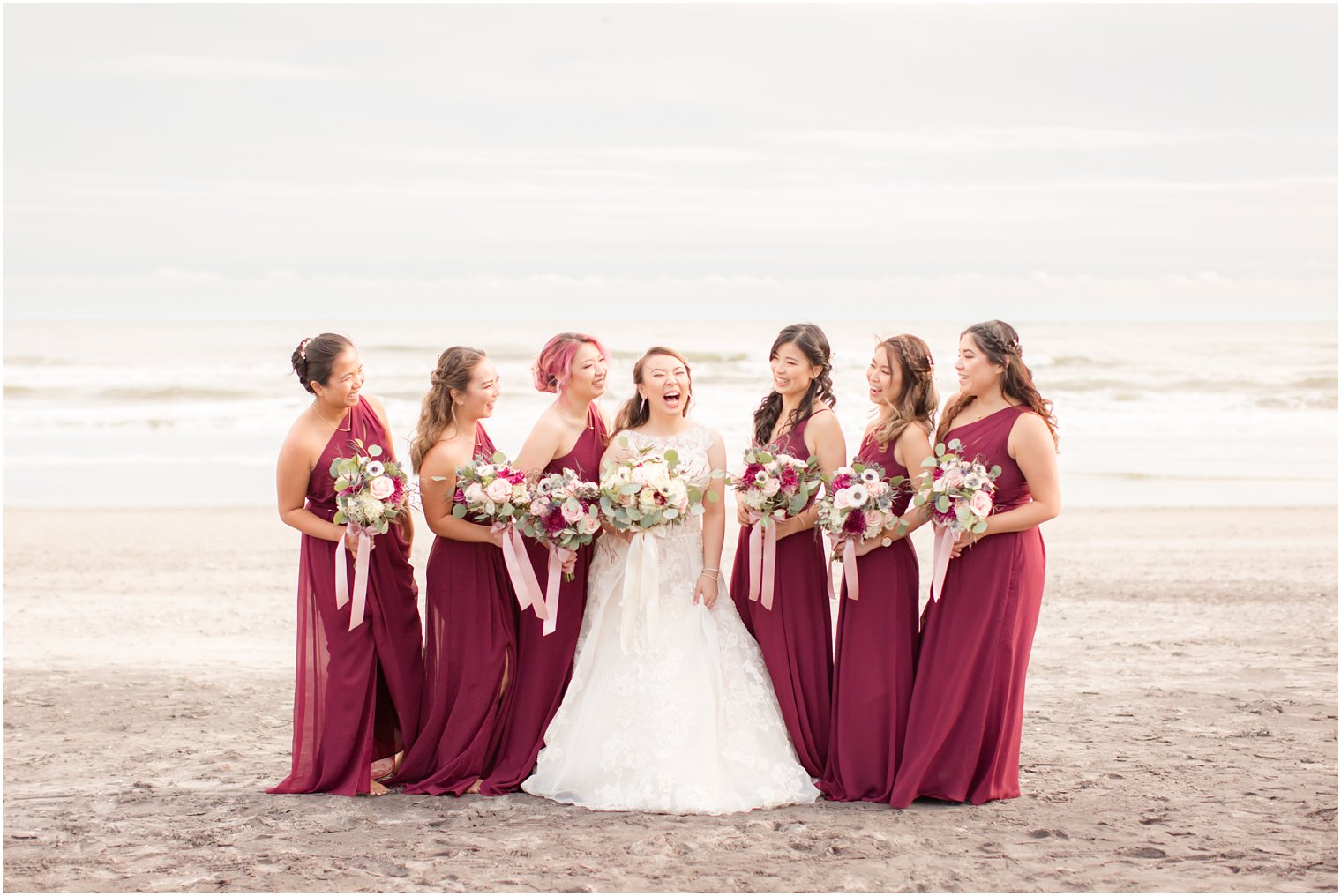 Bride and bridesmaids wearing burgundy and dusty rose for fall wedding 