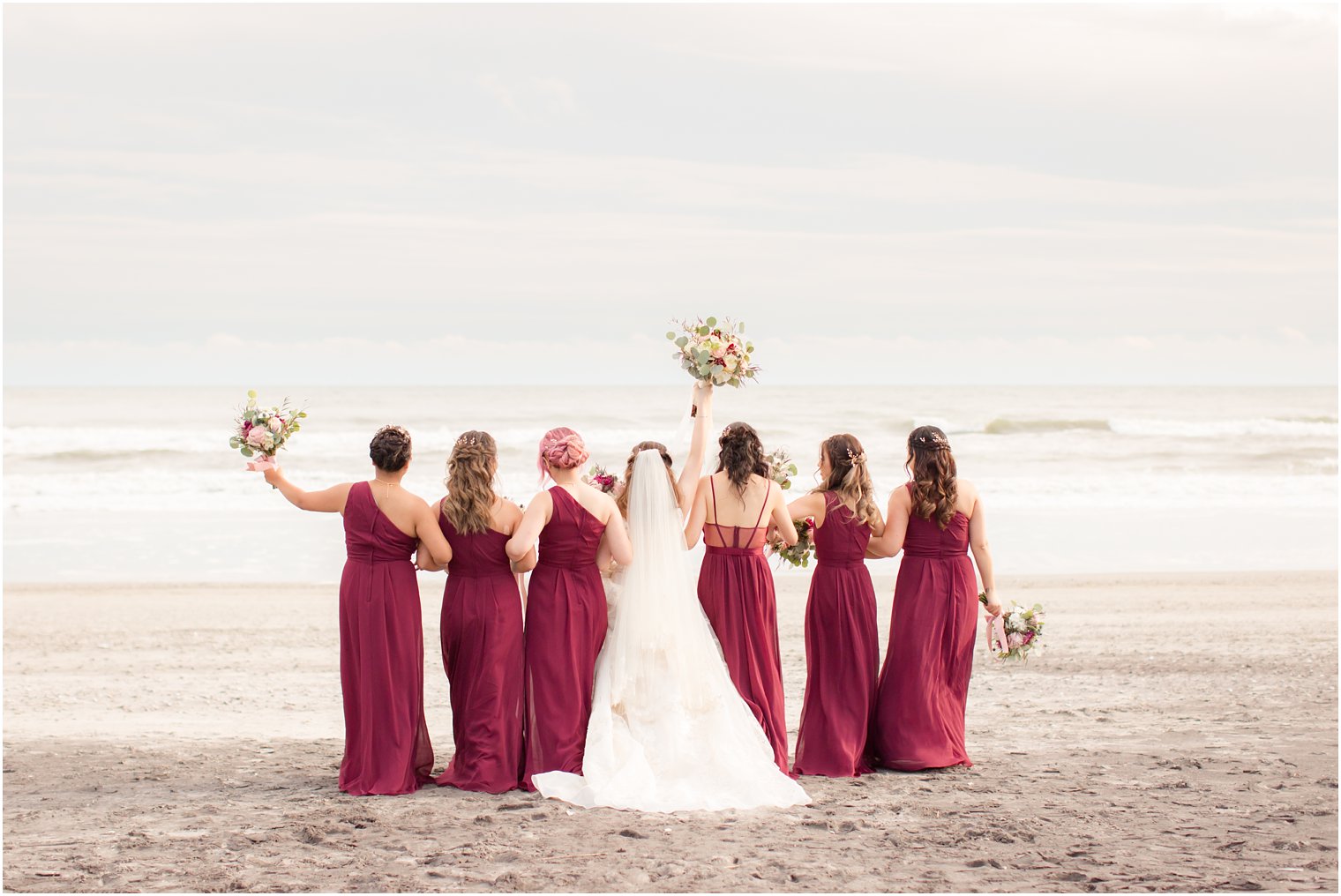 Bridesmaids in burgundy dresses on the beach in Atlantic City, NJ