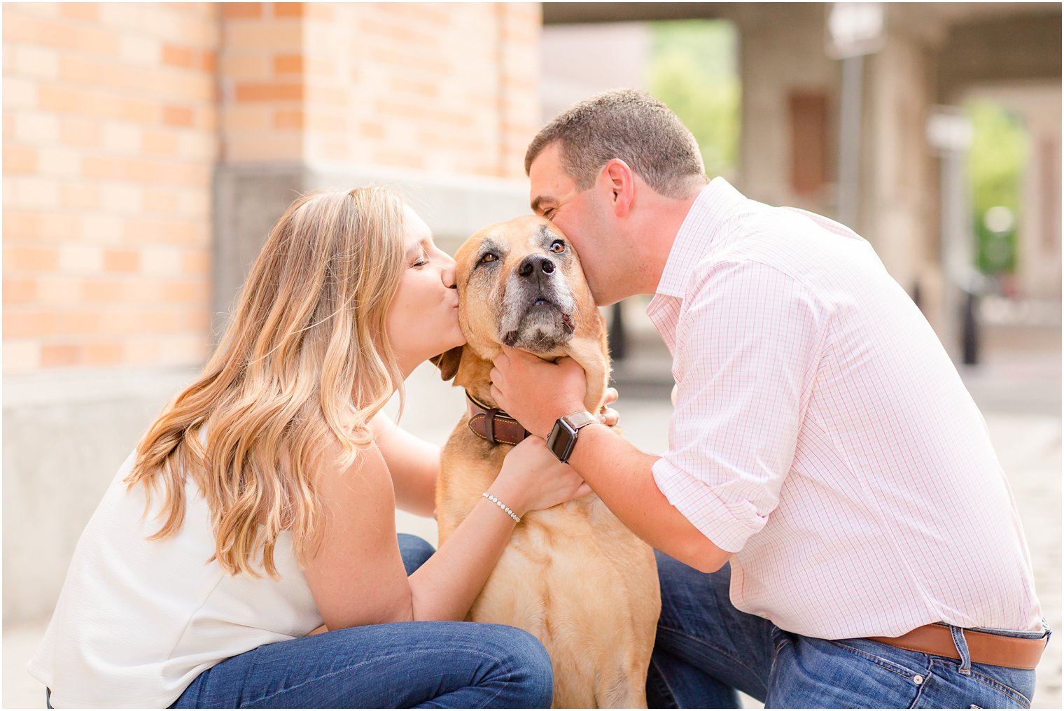 engaged couple kiss dog in Hoboken NJ portraits