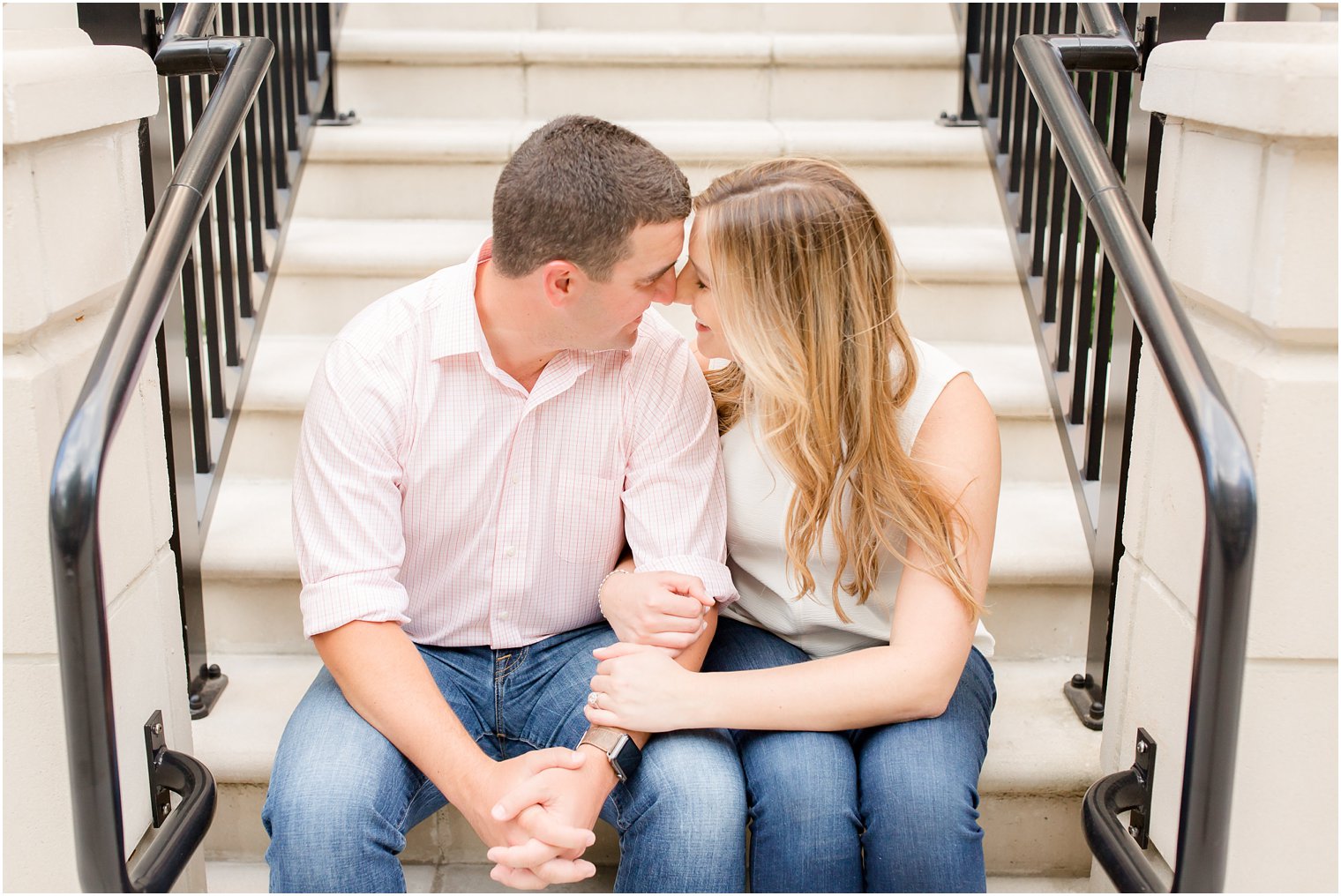 Engaged couple in front of Hoboken apartment