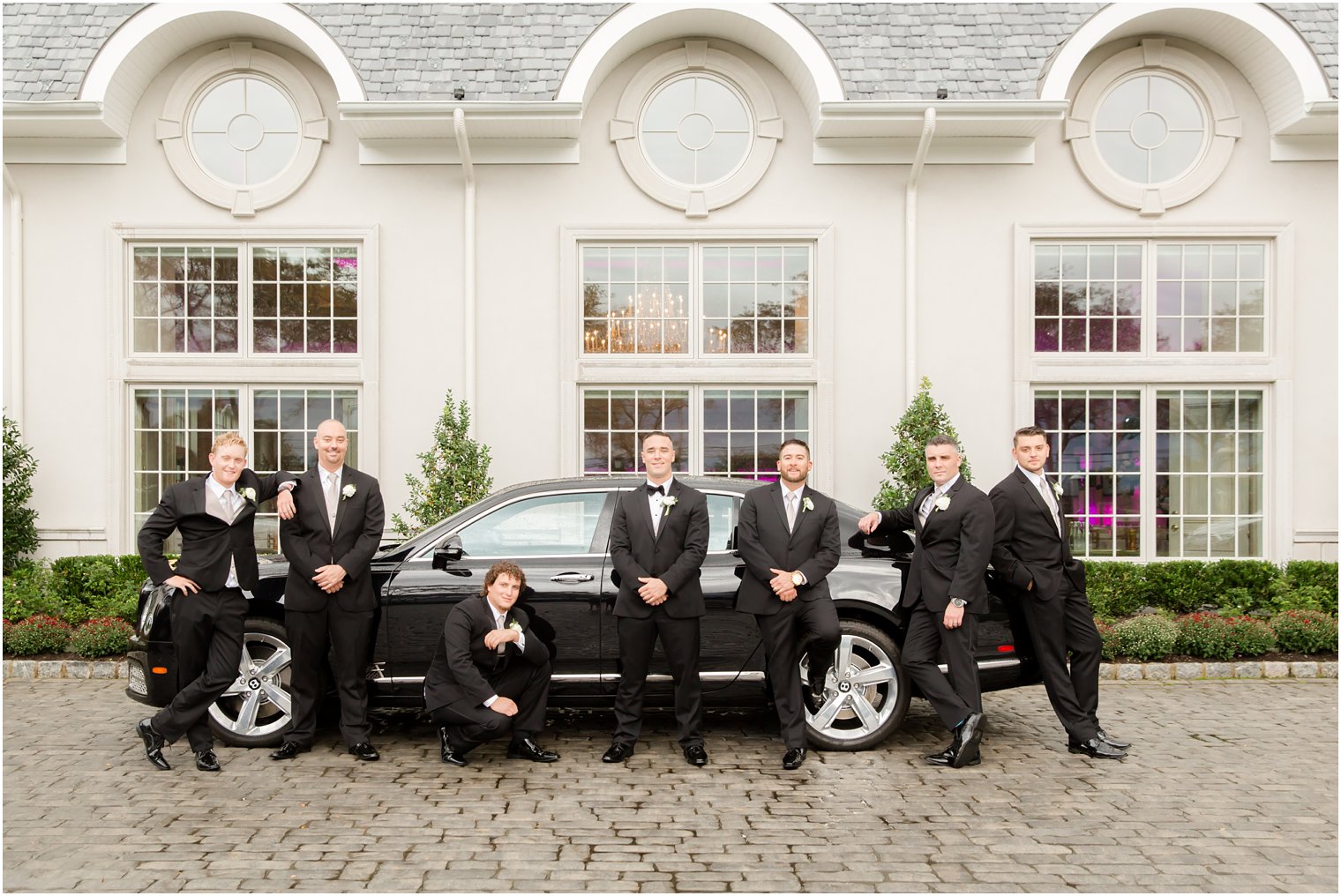 Groom and groomsmen with Bentley in front of Park Chateau Estate