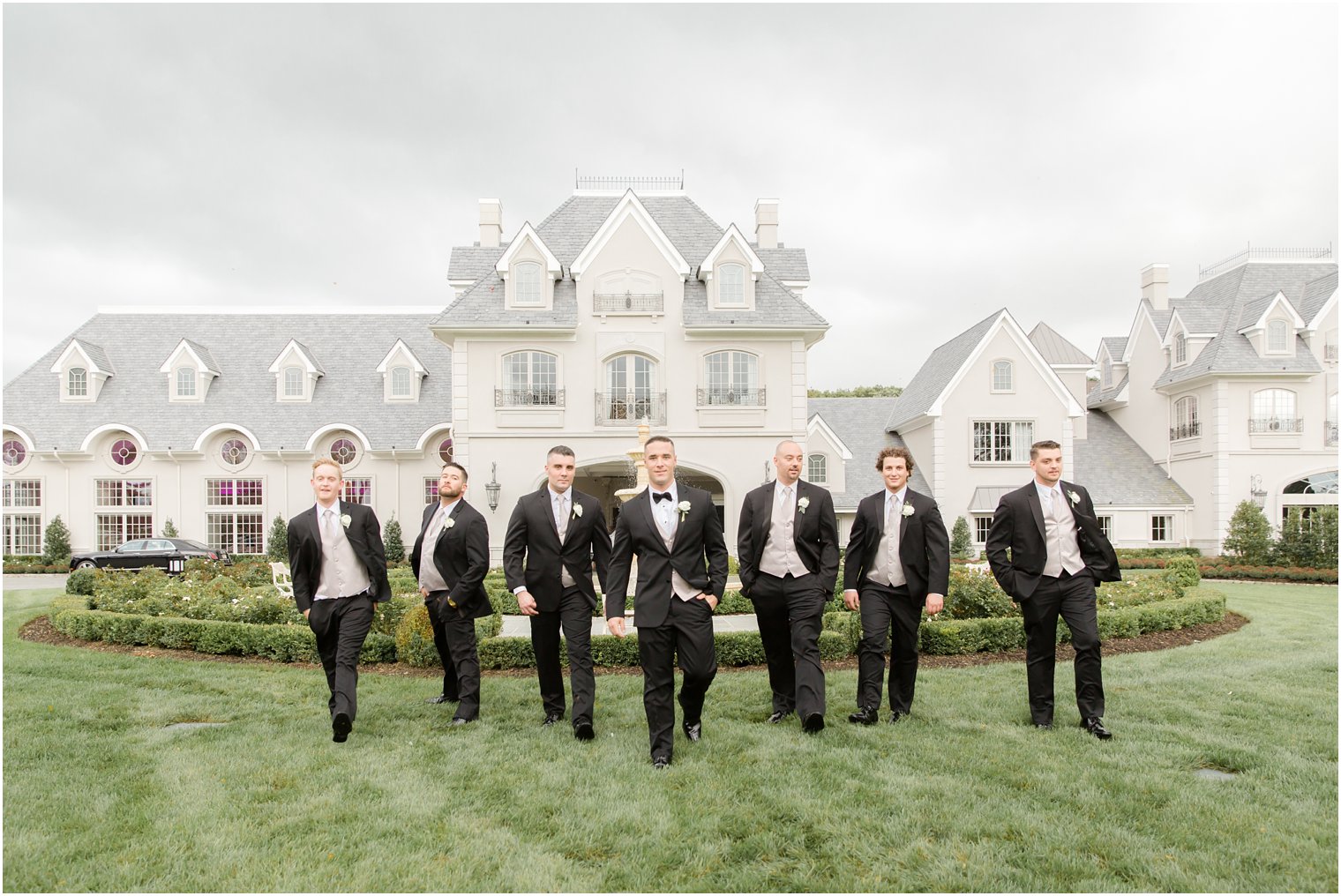 Groom and groomsmen in front of Park Chateau Estate