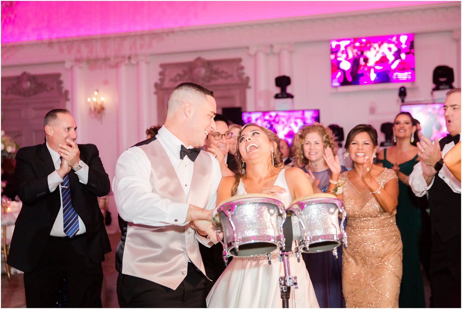 bride and groom play the drums at their wedding reception