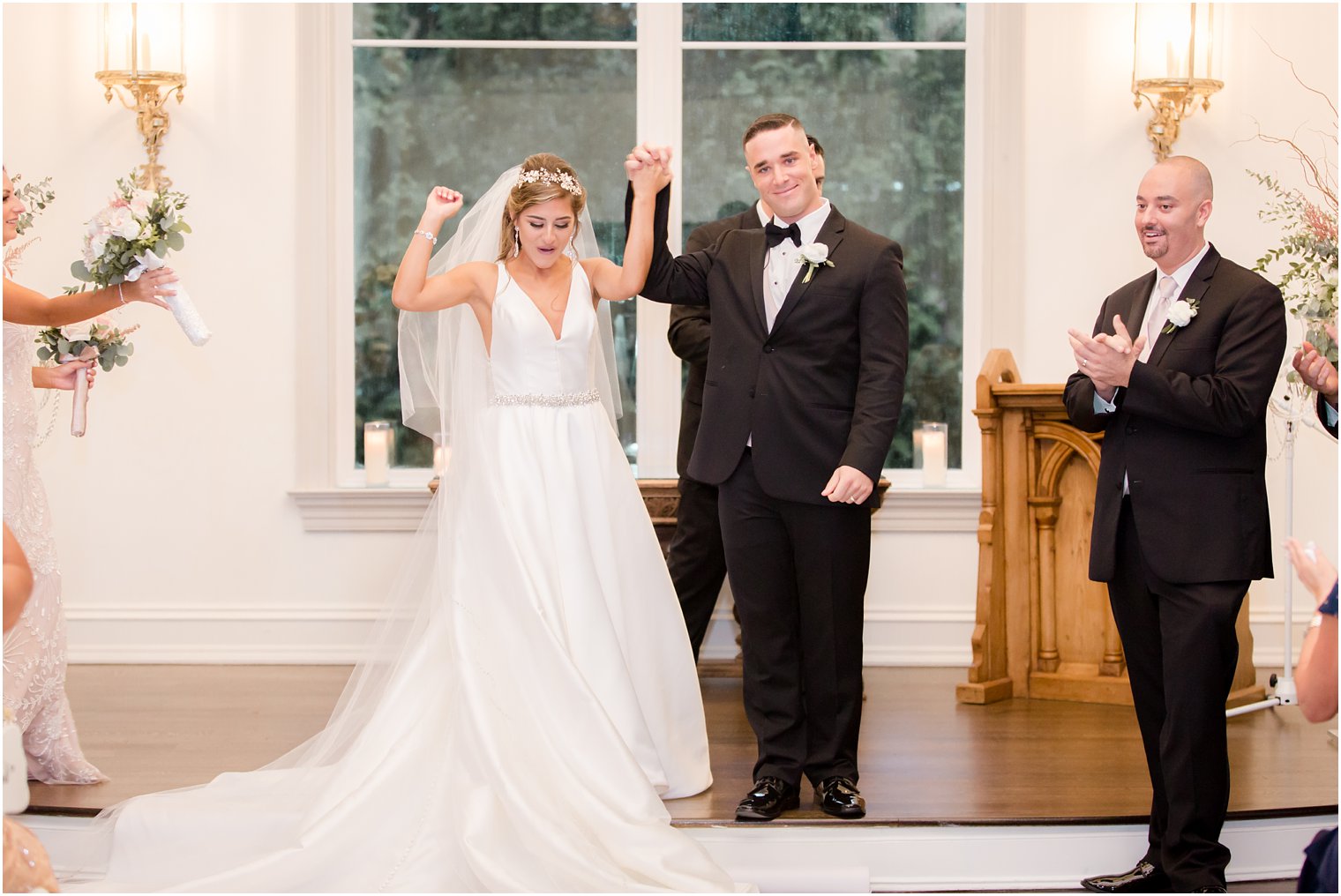 Bride and groom cheering after just having been married
