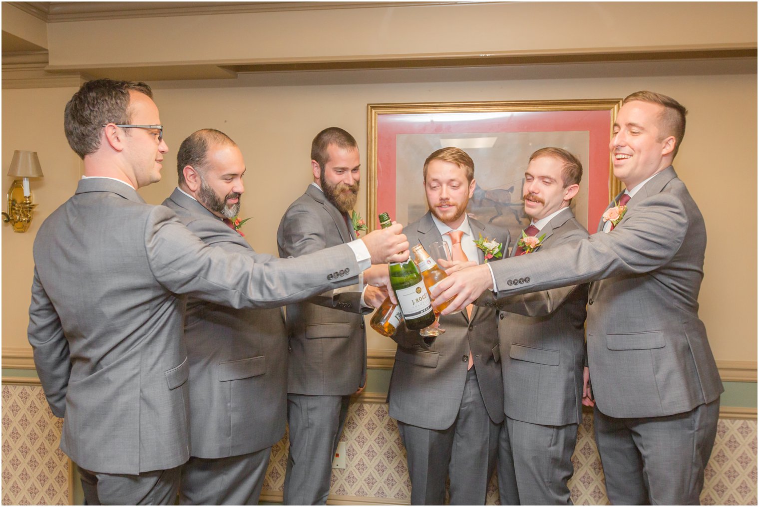 groomsmen cheer wedding day at Olde Mill Inn photographed by Idalia Photography