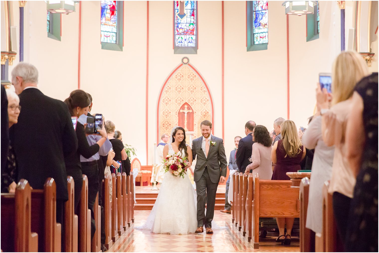 bride and groom walk down aisle photographed by New Jersey wedding photographer Idalia Photography