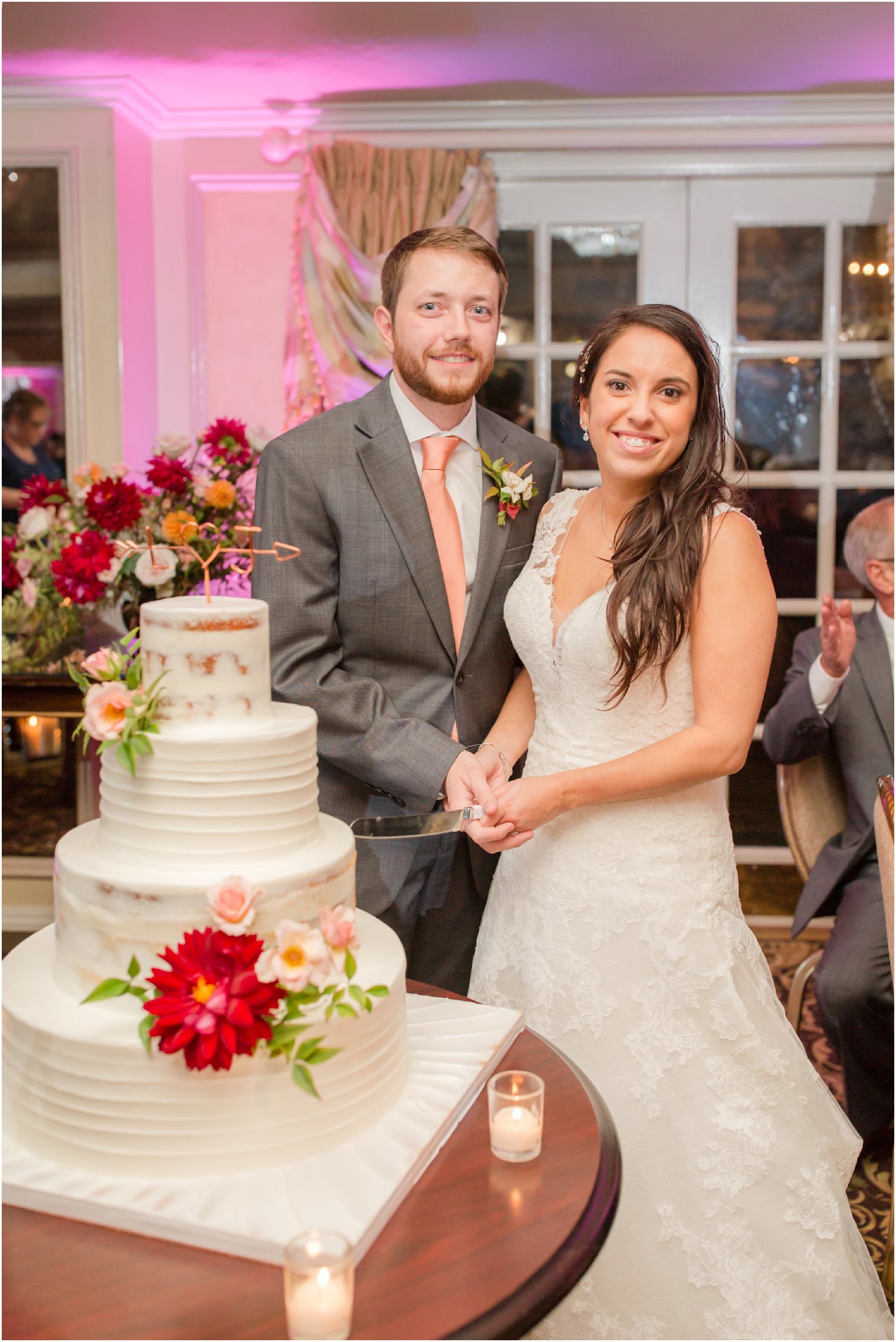 bride and groom with Palermo's Bakery cake photographed by Idalia Photography at Olde Mill Inn wedding 