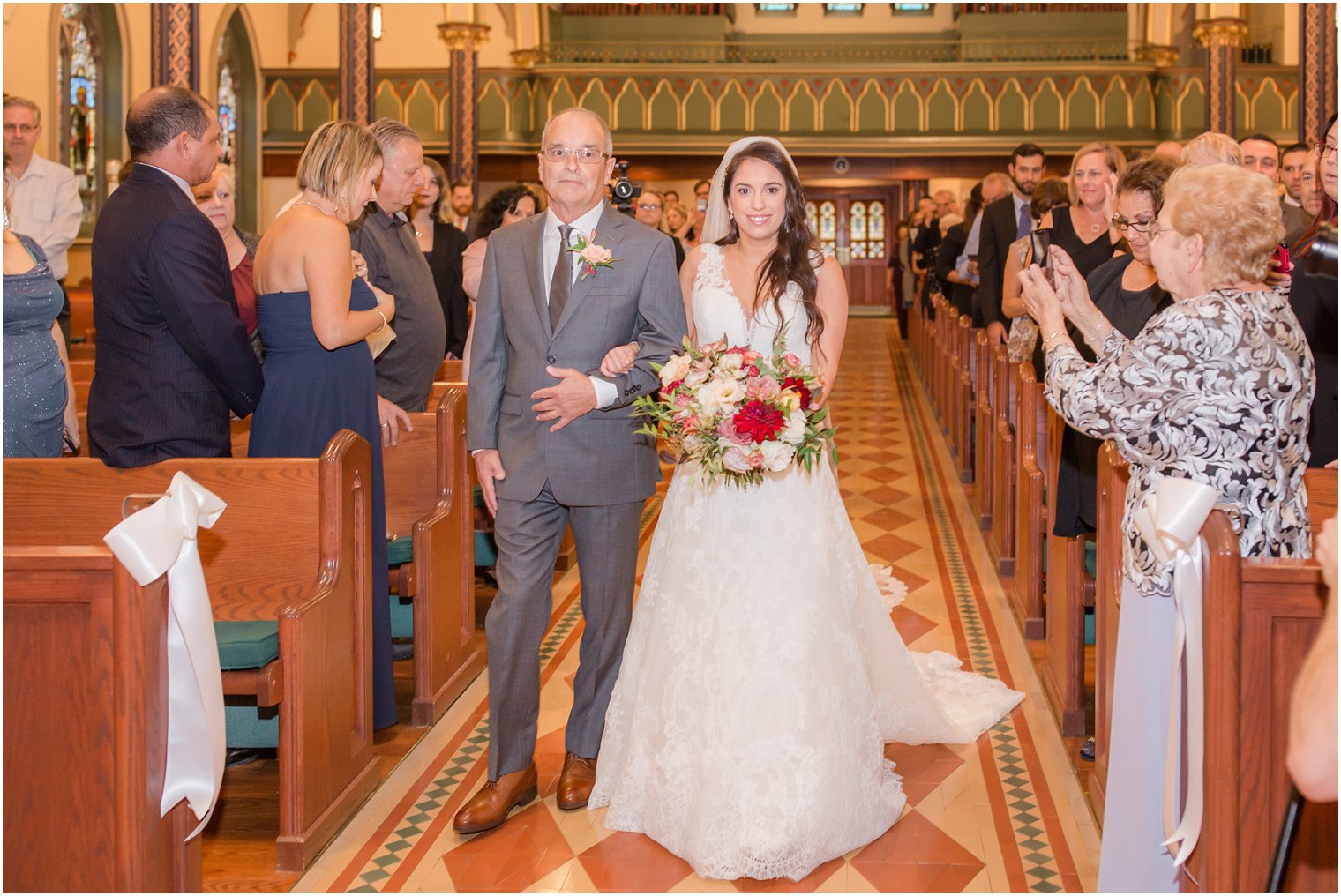 bride walks down aisle at NJ wedding photographed by Idalia Photography