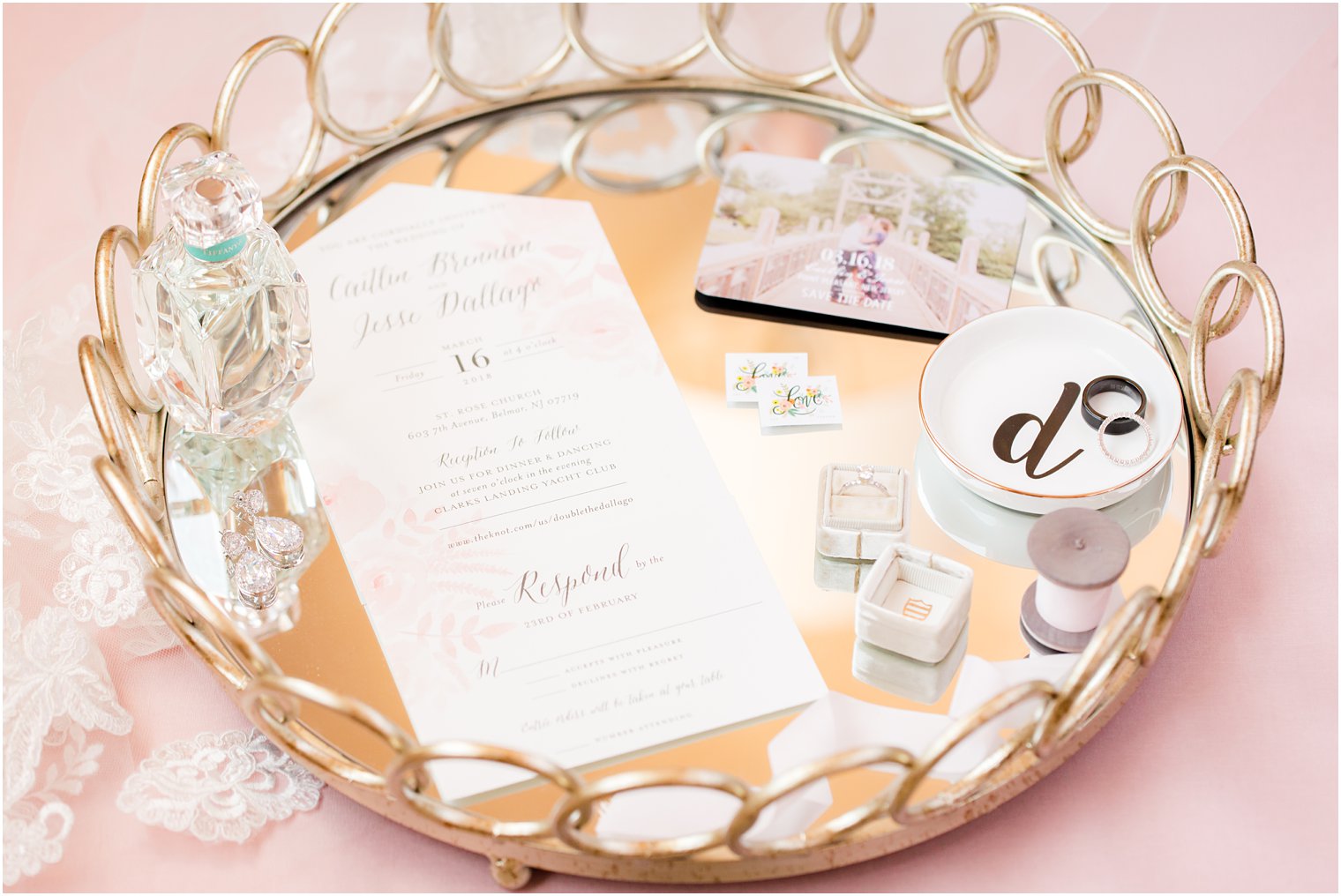 gold tray with invitation and bride's jewelry