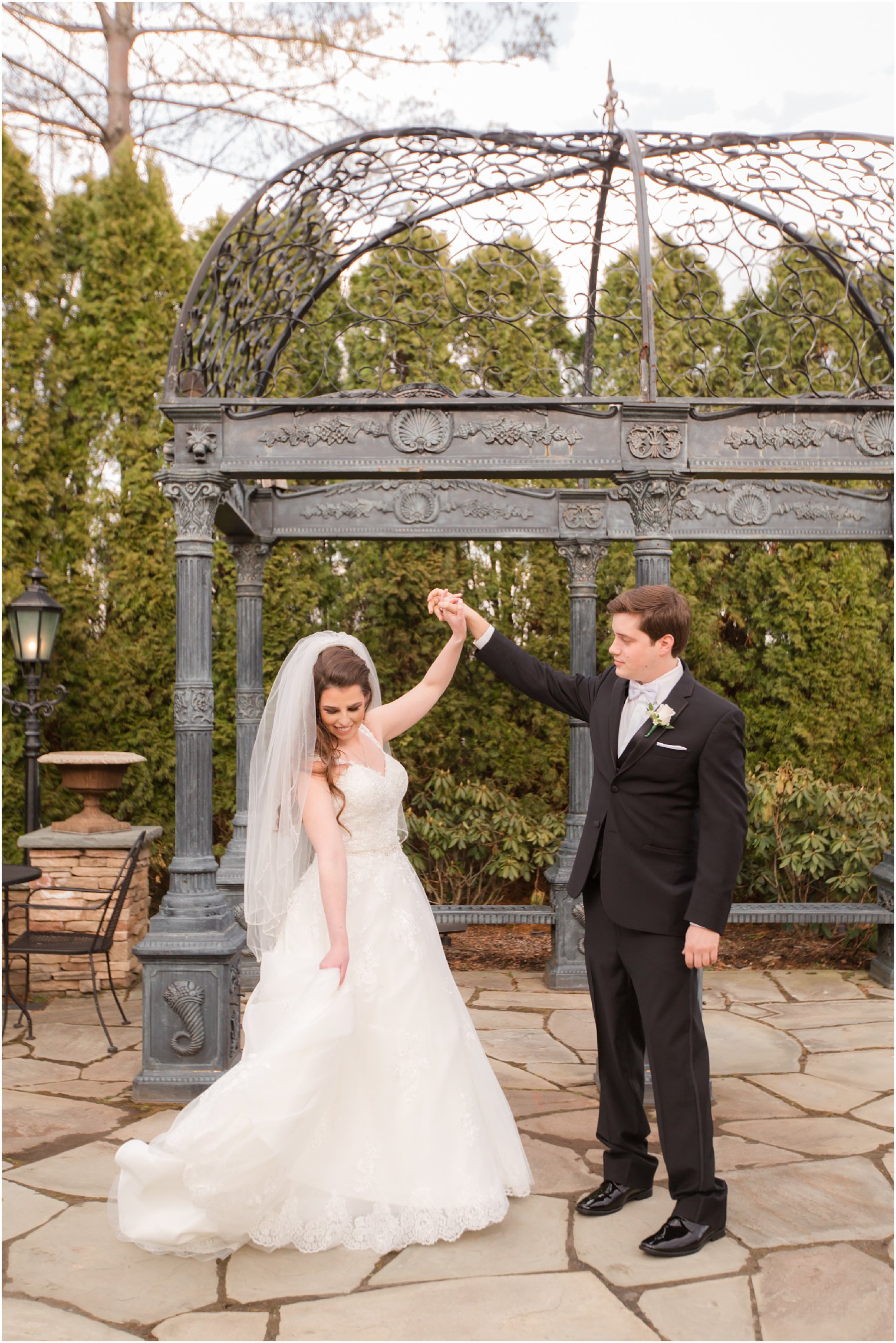 wedding portrait of groom twirling his bride at Park Savoy Estate in Florham Park, NJ