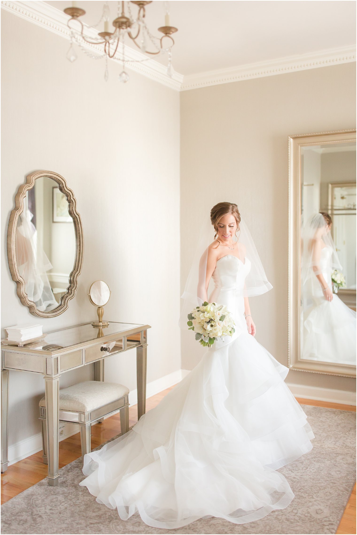 bridesmaid with wedding dress in bridal suite at Pen Ryn Estate wedding in Bensalem, PA