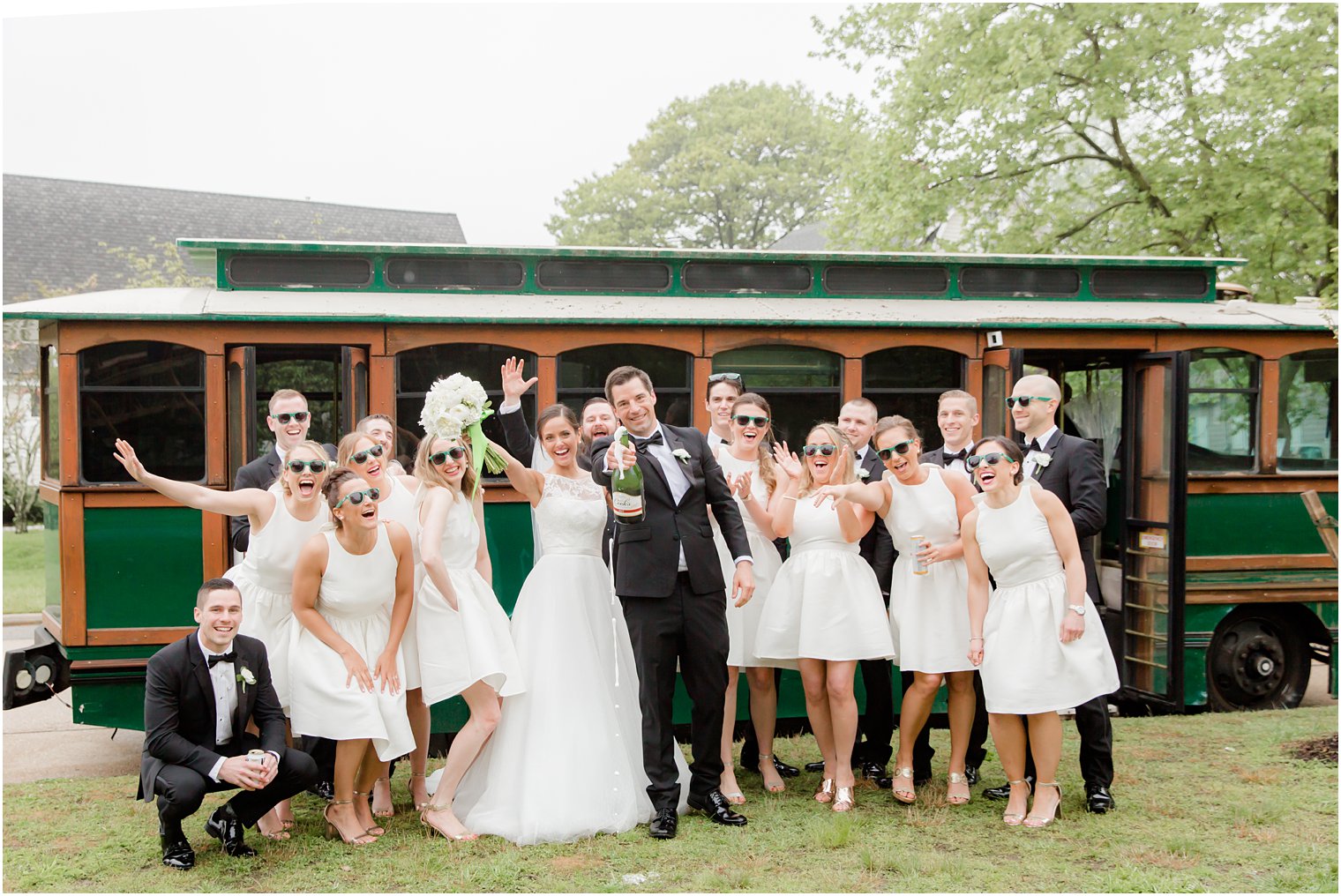 bridal party opening champagne at Divine Park in Spring Lake, NJ