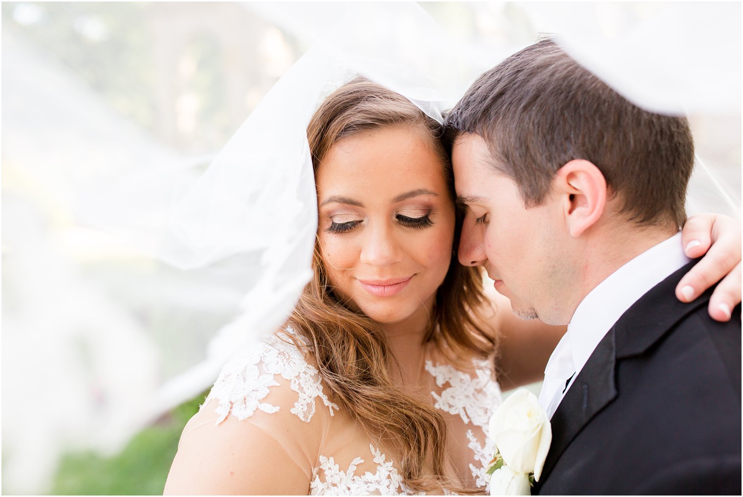 Elegant veiled portrait of bride and groom at Monmouth University