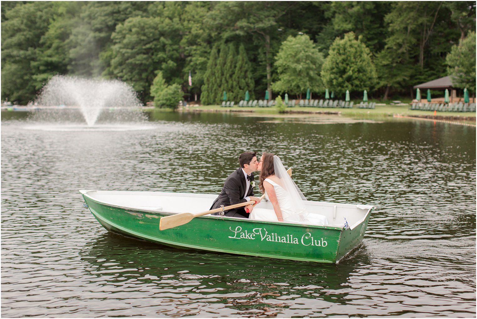 bride and groom in a row boat at Lake Valhalla wedding