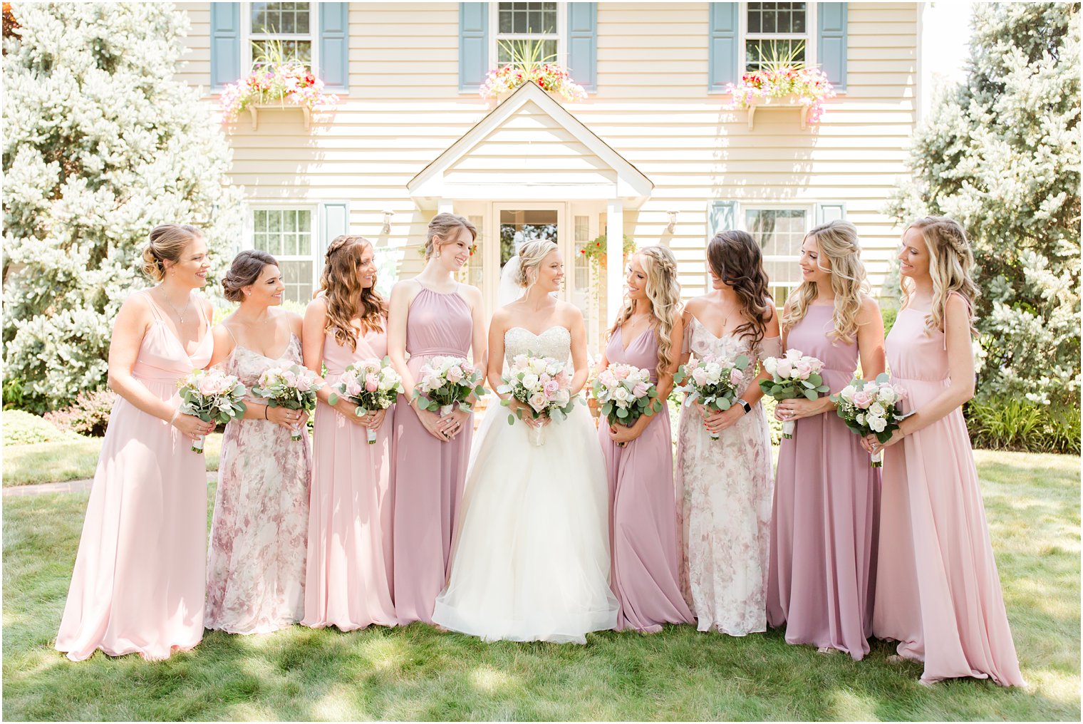 bridesmaids in mismatched dresses in mauve tones
