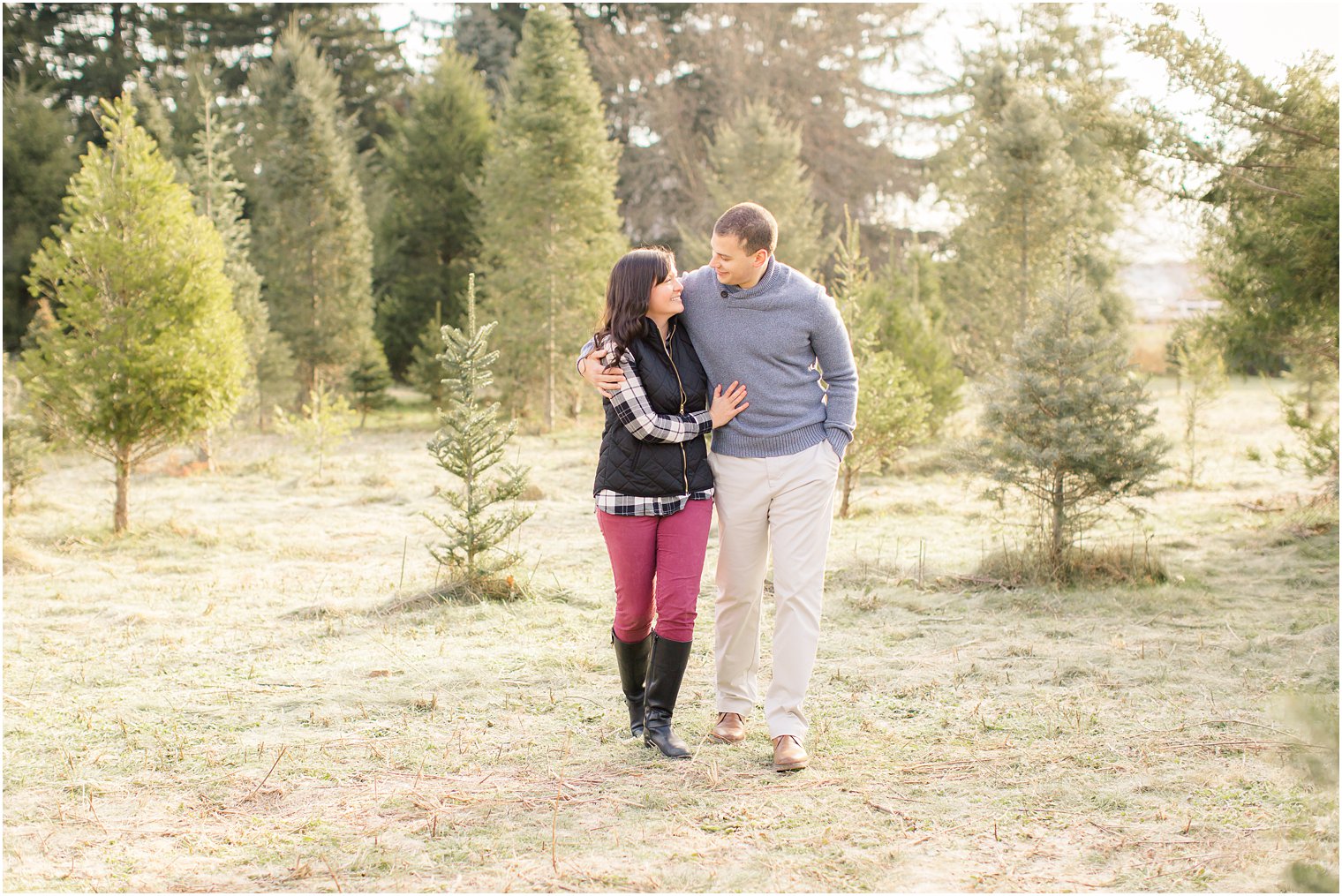 candid photo of engaged couple during their Christmas tree farm engagement