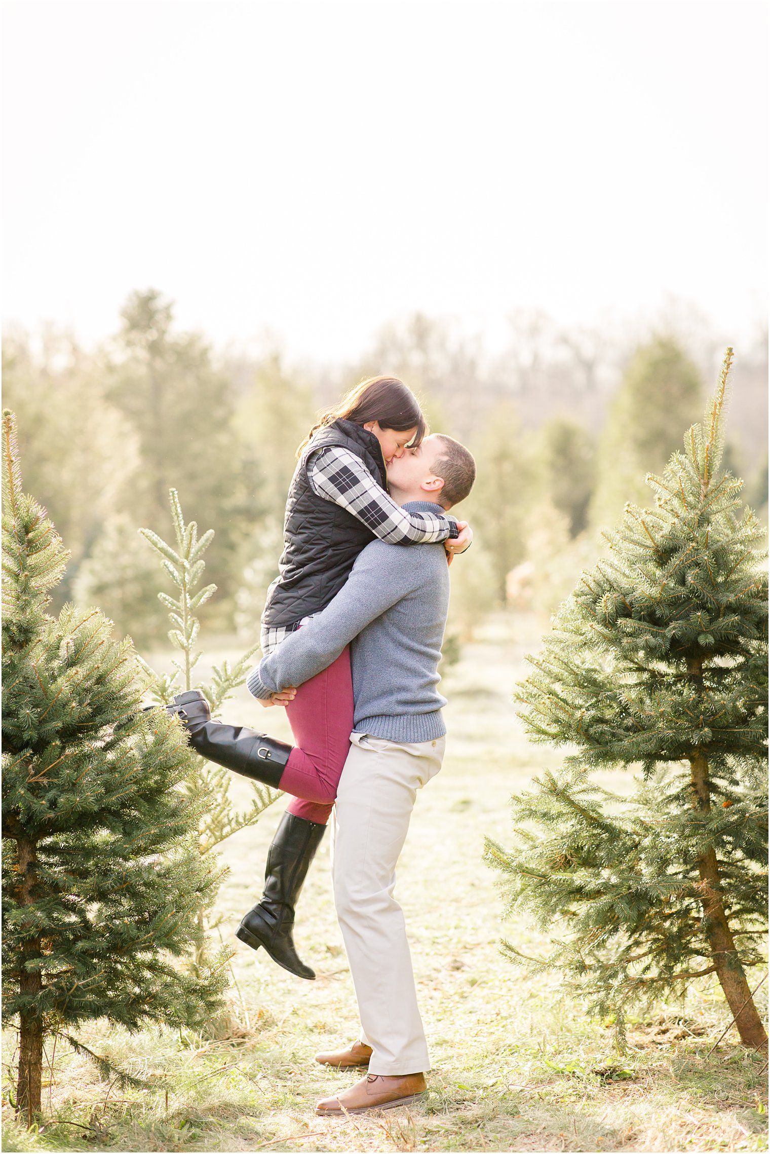 engaged couple at their Christmas tree farm engagement