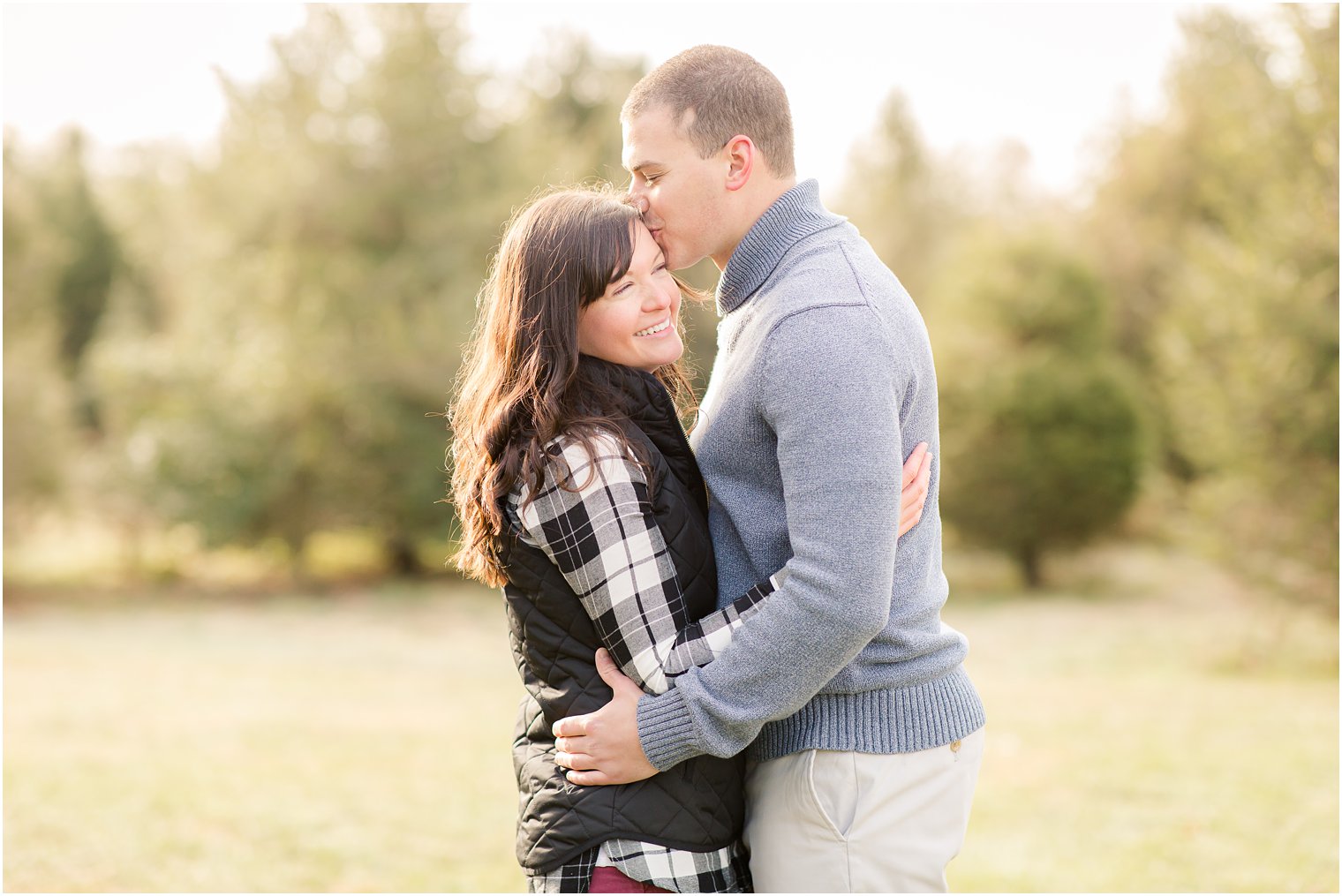 laughing bride during Christmas tree farm engagement