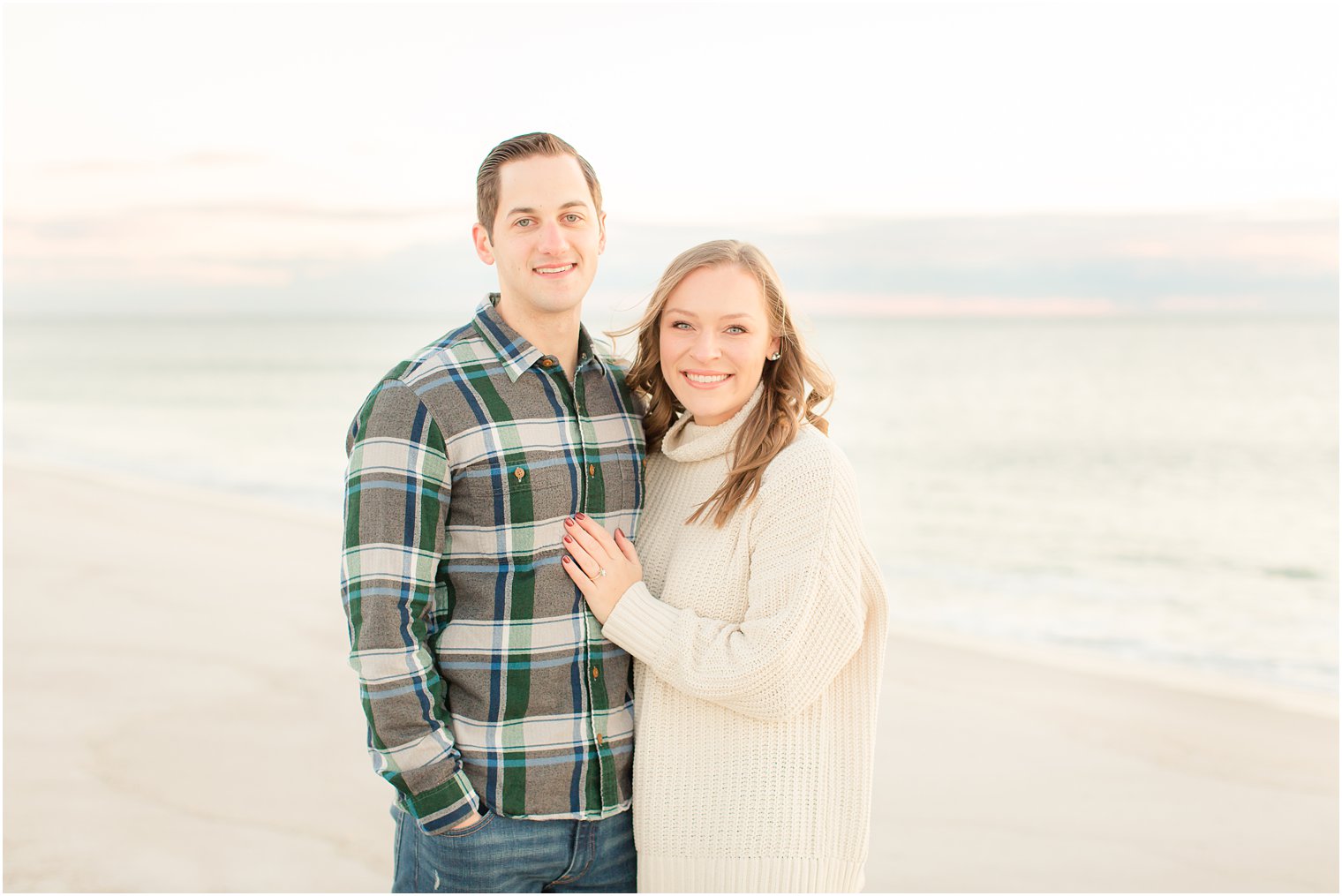 engaged couple taking fall engagement photos on the Jersey Shore