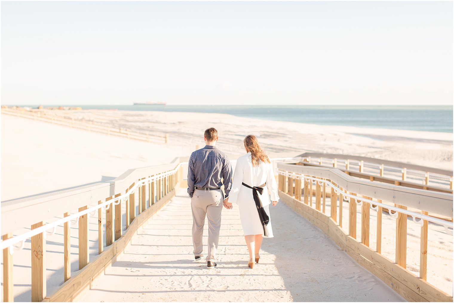 couple walking down to the beach in Lavallette