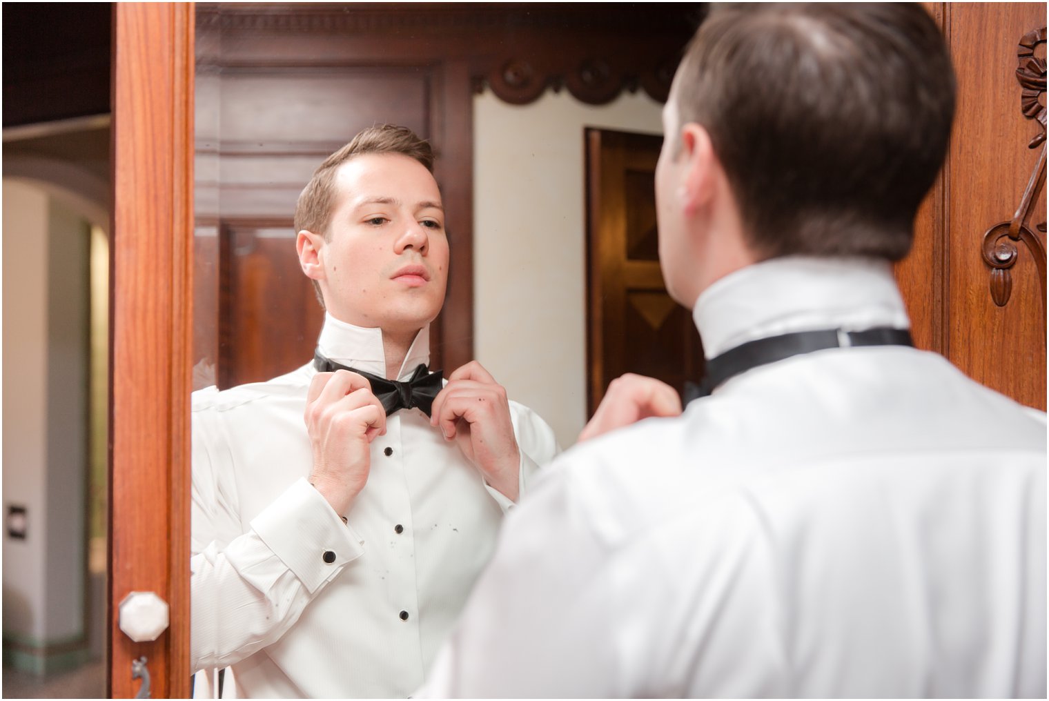 groom putting on bow tie