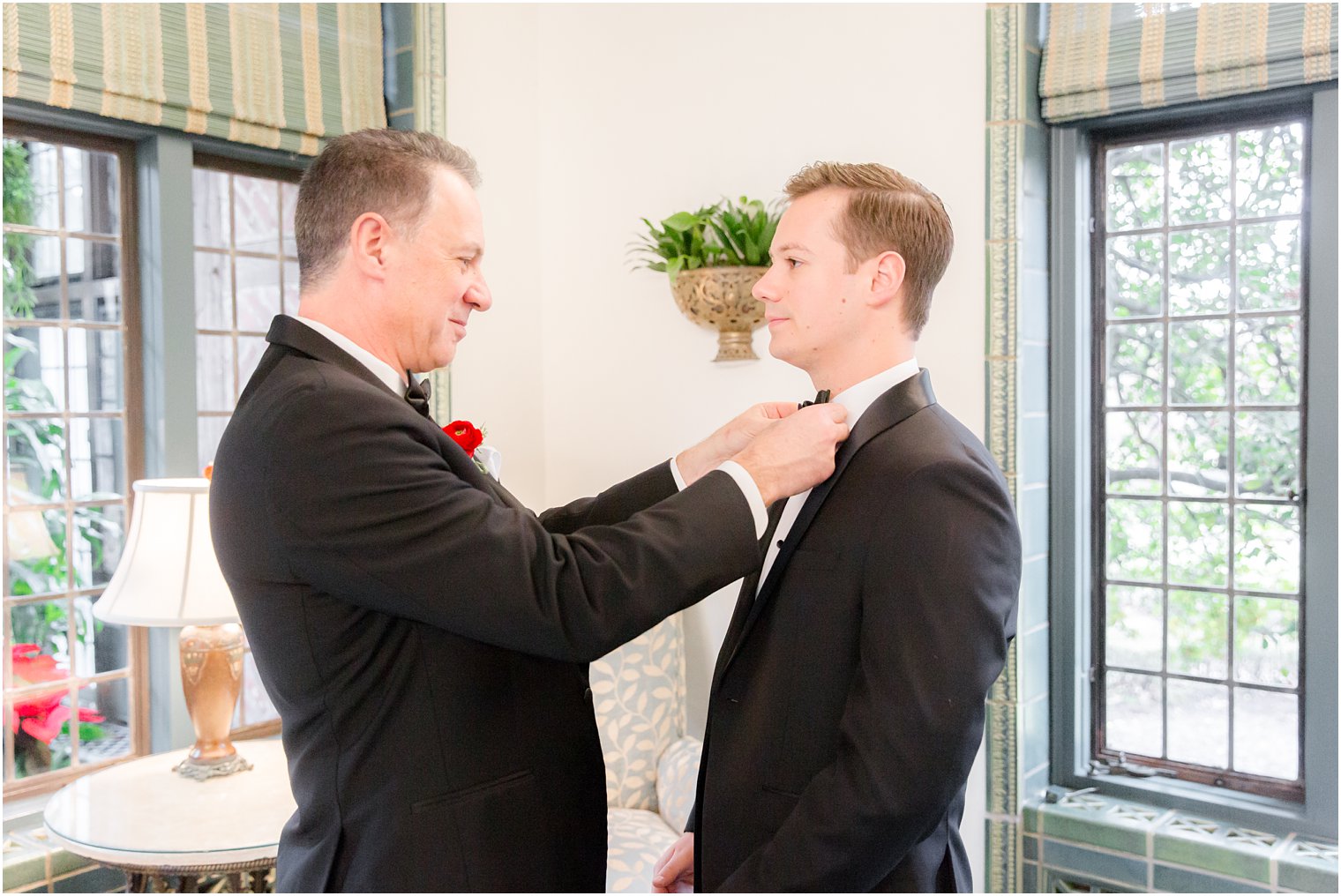 groom getting ready with father