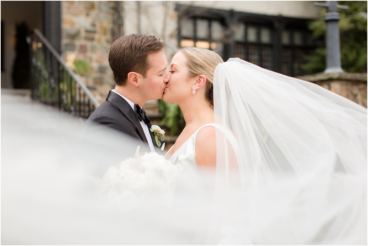 groom kissing his bride at Pleasantdale Chateau