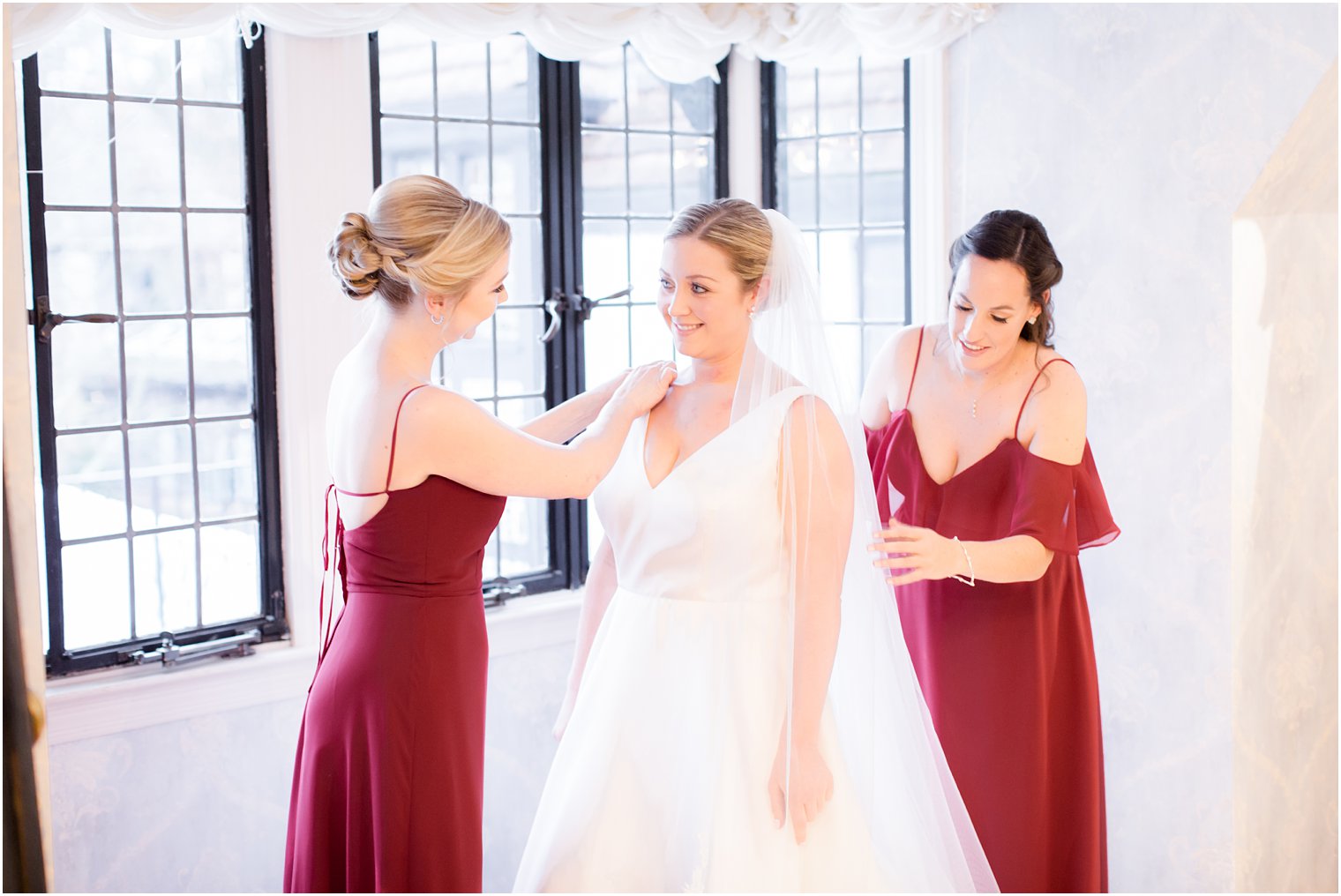 maids of honor helping bride get dressed