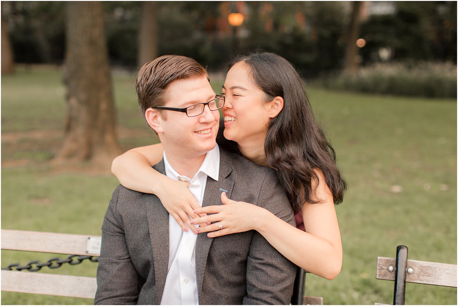 candid photo of engaged couple on a park bench