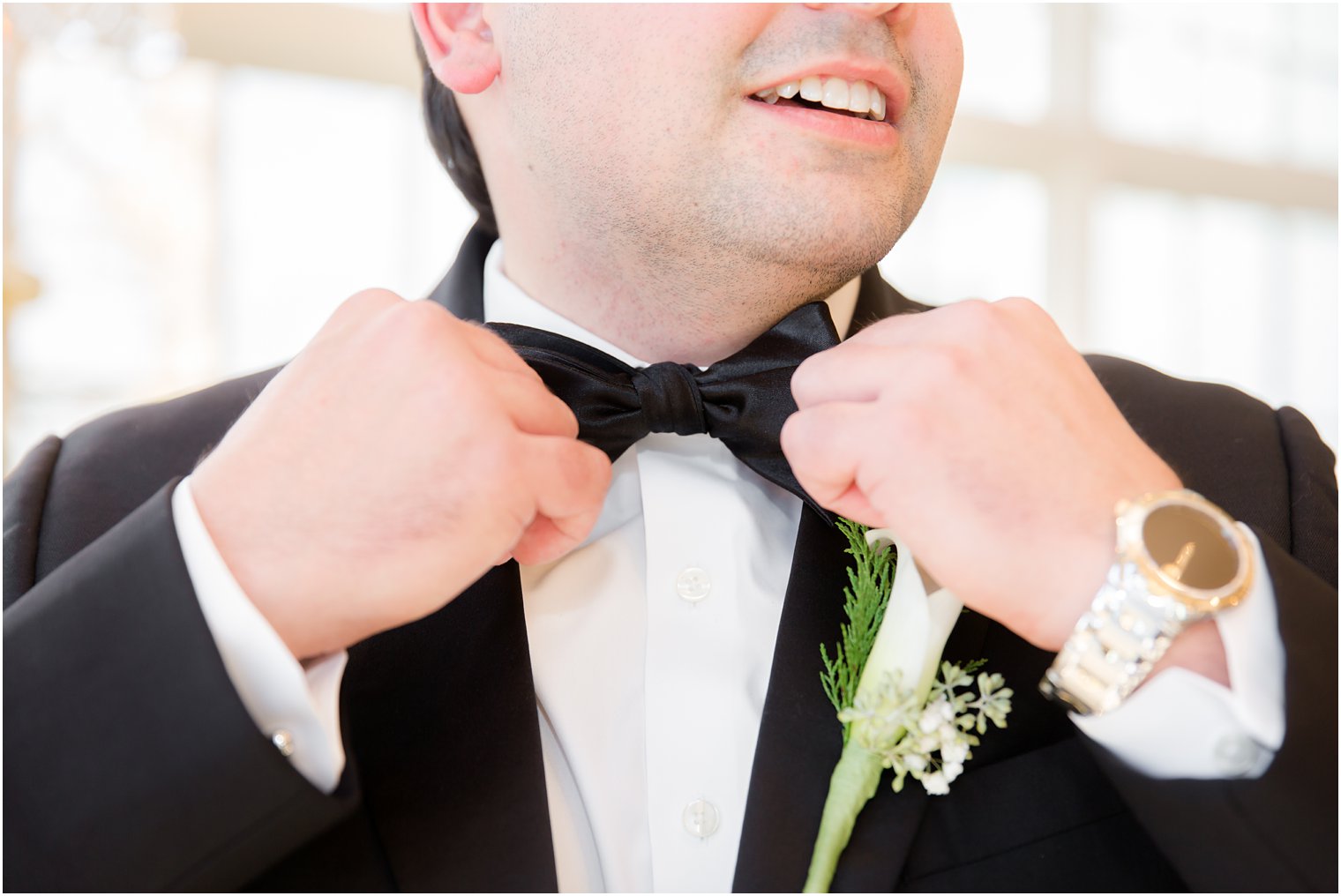 groom straightening out bow tie