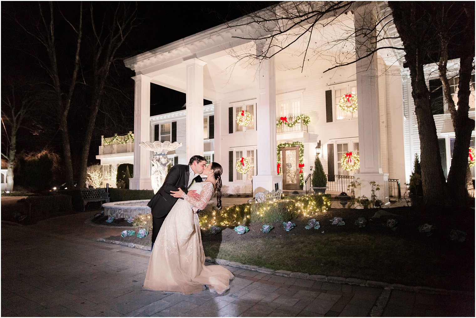 Night photo of bride and groom in front of Park Savoy Estate
