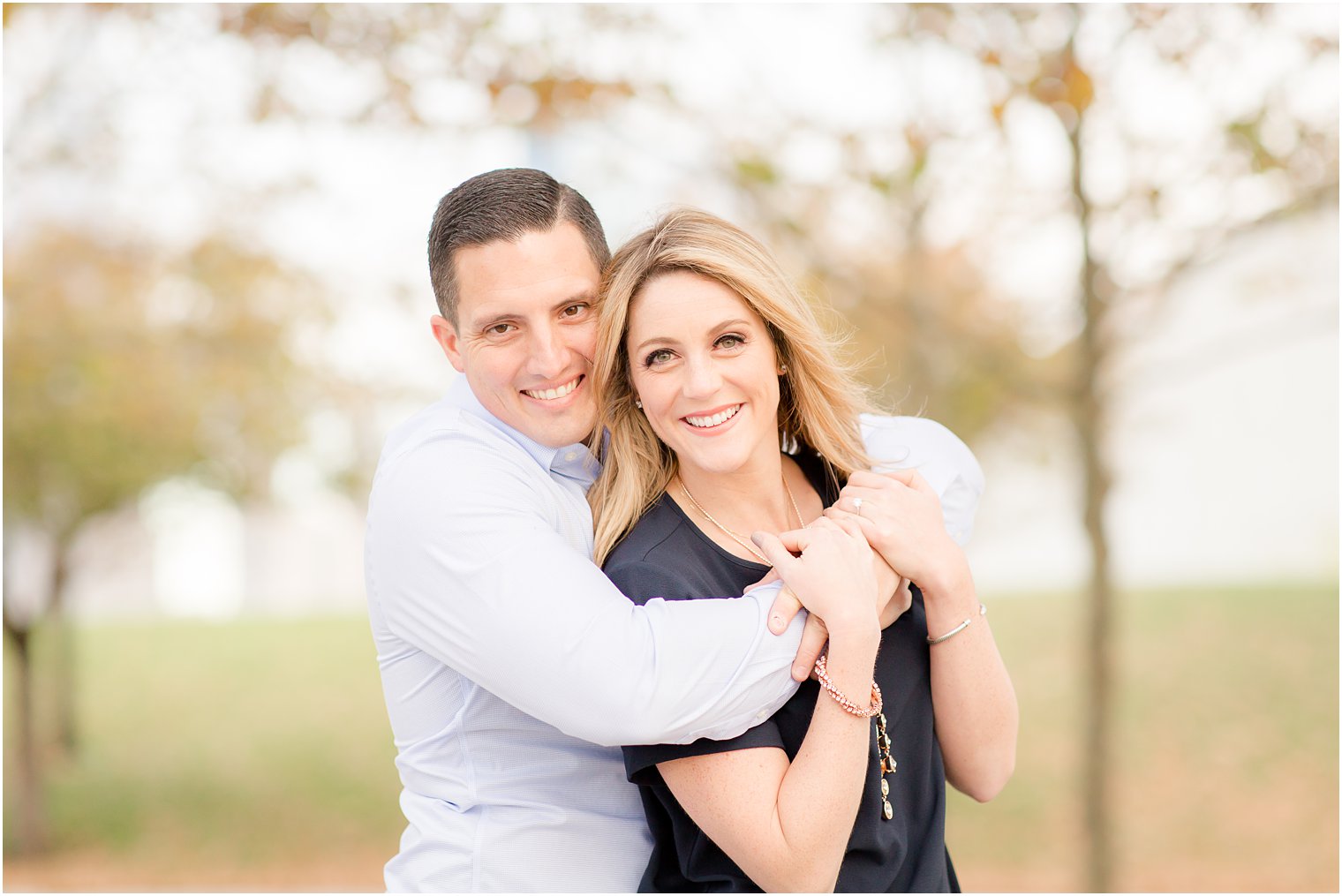 Happy couple posing for engagement photos