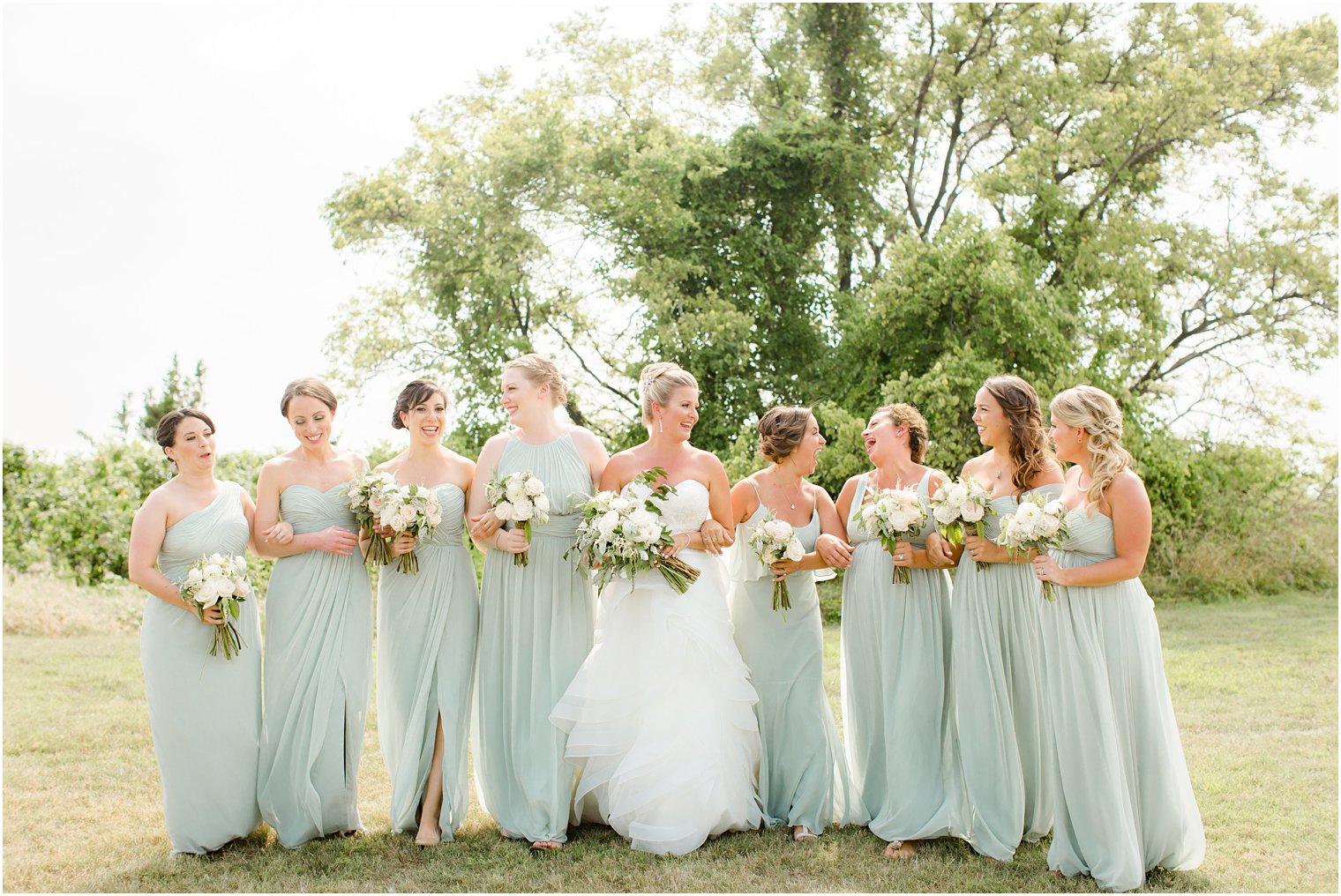 Bridesmaids walking with florals by Faye and Renee